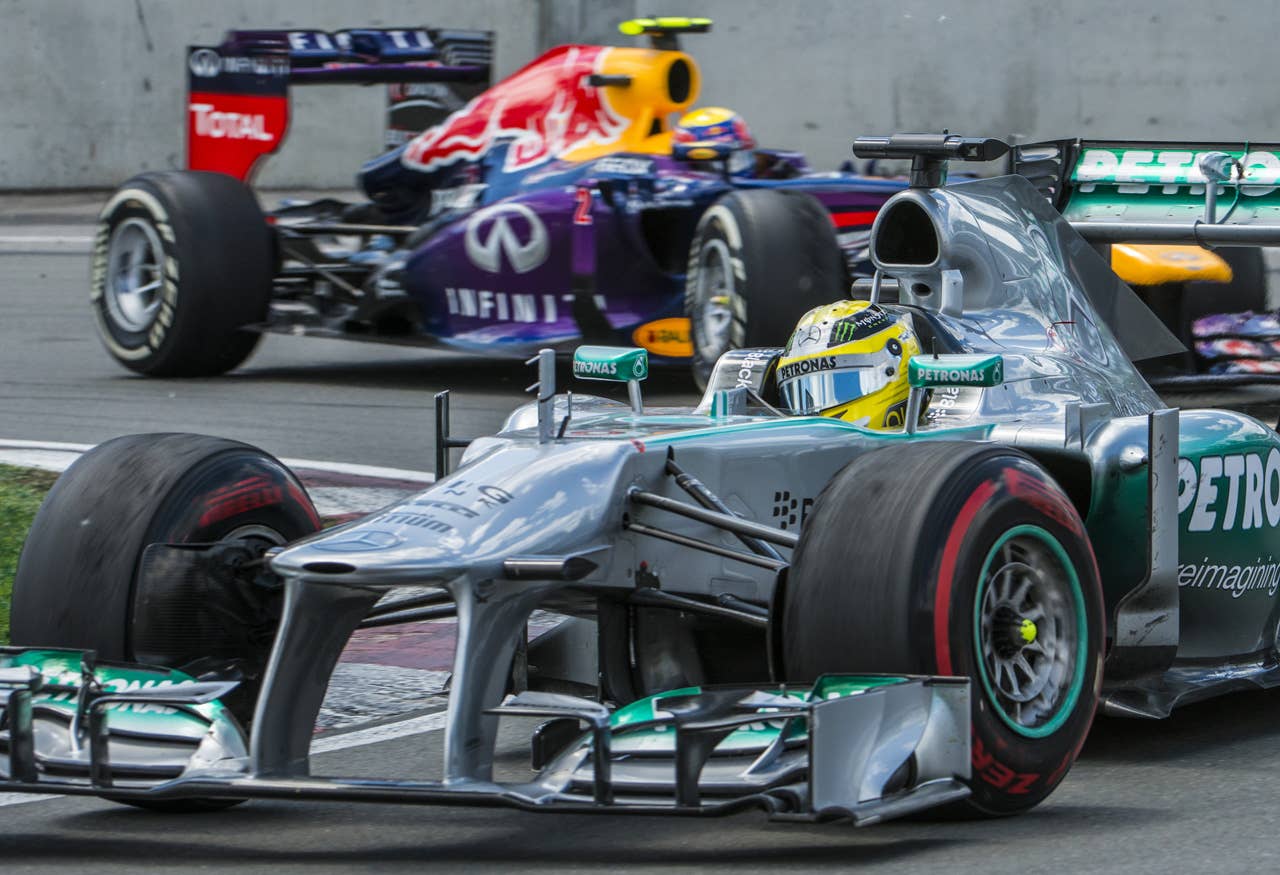 Mercedes driver Lewis Hamilton of Britain leads in front of Red Bull Racing Mark Webber of Australia in the hairpin corner at the Circuit Gilles Villeneuve in Montreal on June 9, 2013 during the Canadian Formula One Grand Prix.   AFP PHOTO / ROGERIO BARBOSAROGERIO BARBOSA/AFP/Getty Images