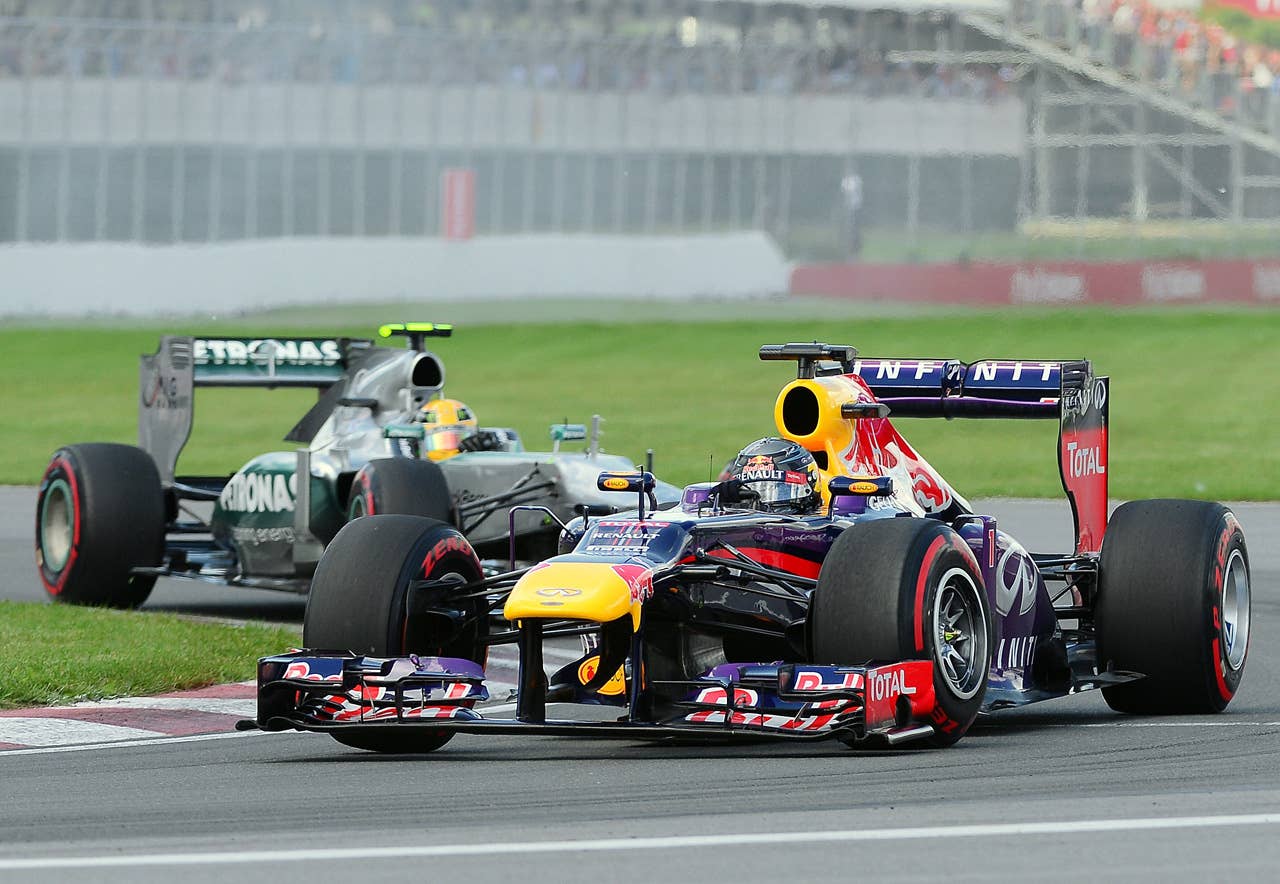 Red Bull driver Sebastian Vettel of Germany (R) leads Mercedes driver Lewis Hamilton of Britain (L) in the first lap of the Canadian Formula One Grand Prix at the Circuit Gilles Villeneuve in Montreal on June 9, 2013. AFP PHOTO/Emmanuel DUNANDEMMANUEL DUNAND/AFP/Getty Images