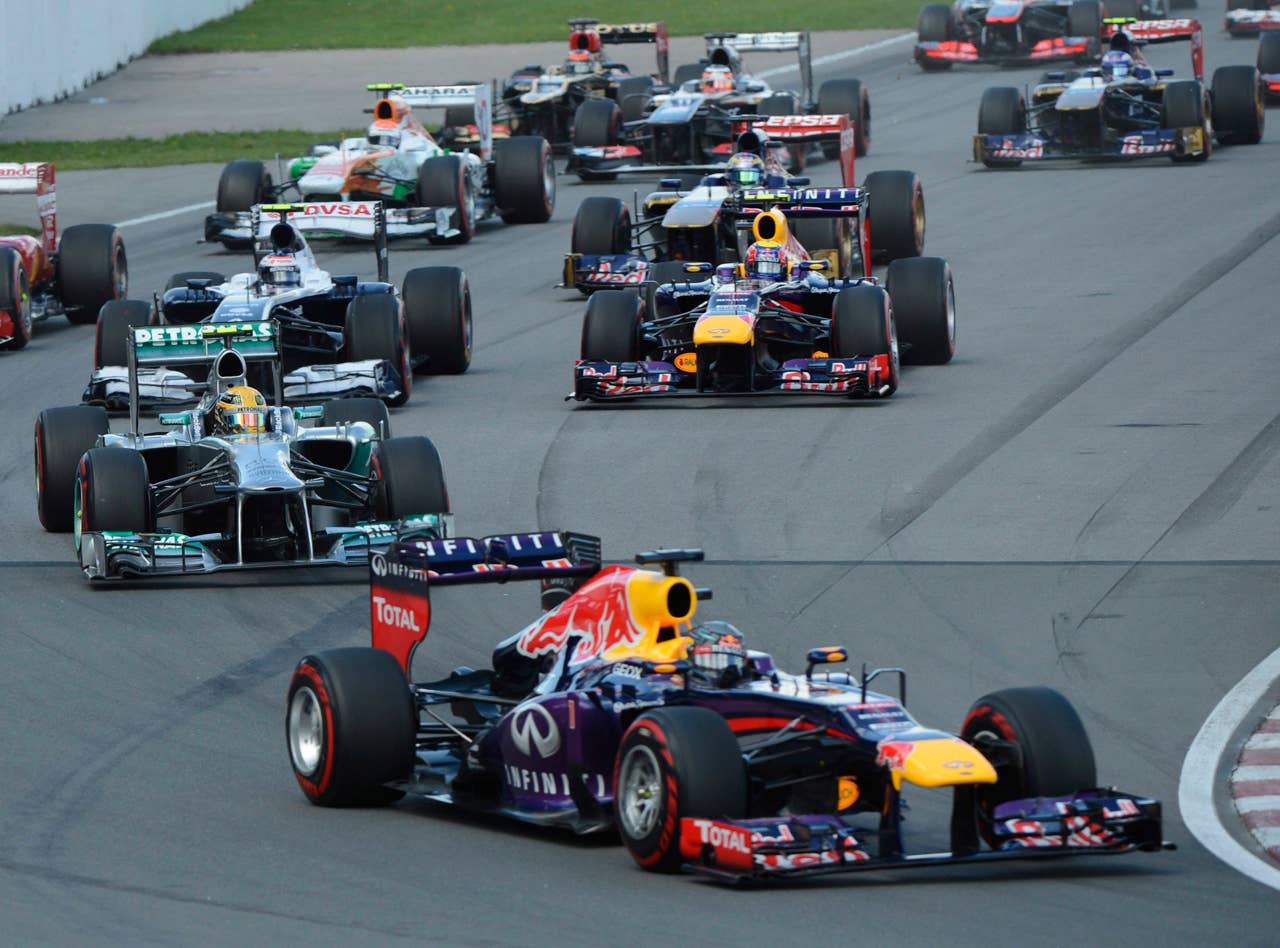 Red Bull driver Sebastian Vettel, of Germany, leads the pack at the start of the Canadian Grand Prix auto race in Montreal, Sunday, June 9, 2013. (AP Photo/The Canadian Press, Ryan Remiorz)