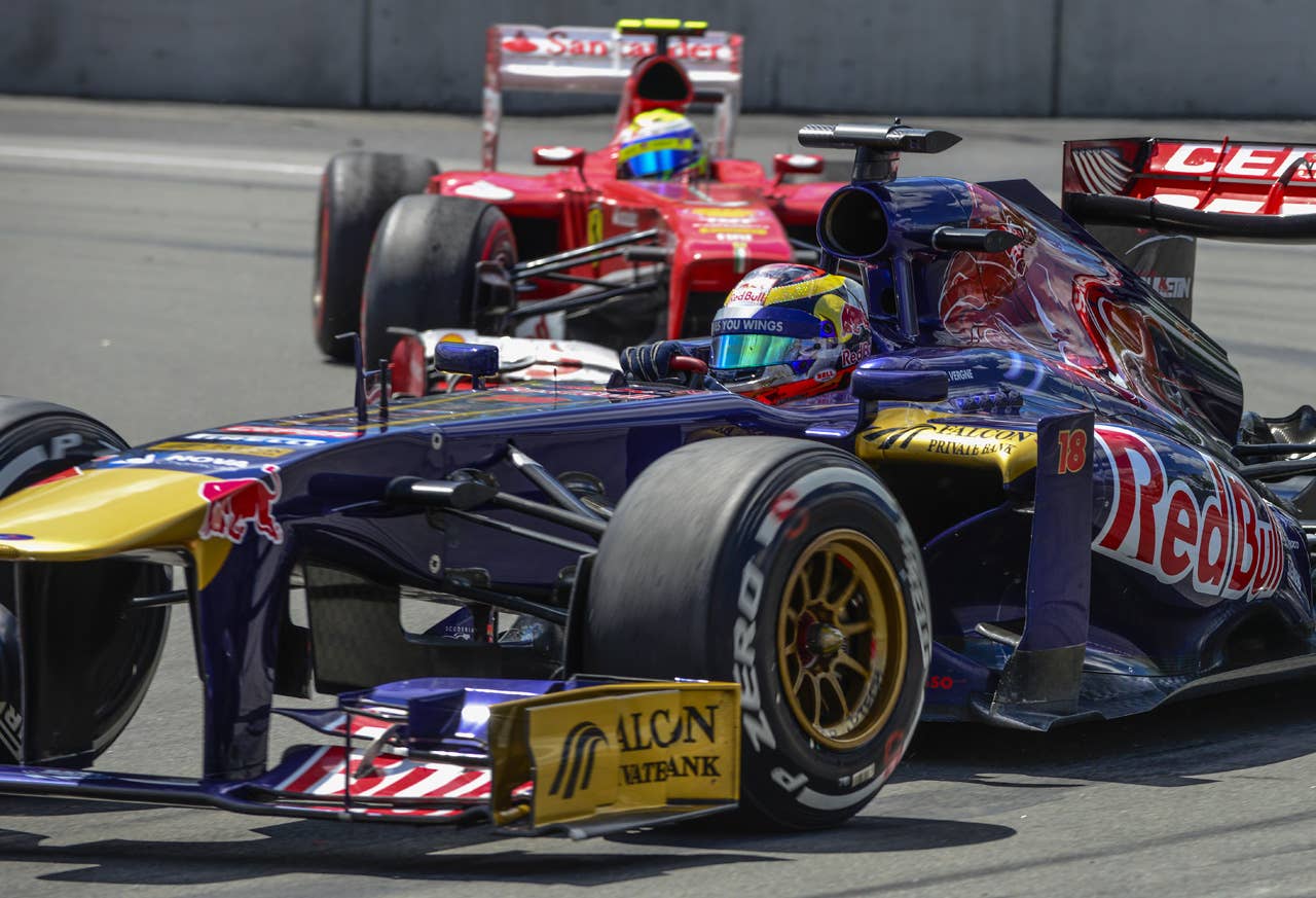 Scuderia Toro Rosso Jean-Eric Vergne of France in front of Scuderia Ferrari Felipe Massa of Brazil in the hairpin corner, during the F1 Grand Prix race at the Circuit Gilles Villeneuve in Montreal on June 9, 2013 during the Canadian Formula One Grand Prix.   AFP PHOTO / ROGERIO BARBOSAROGERIO BARBOSA/AFP/Getty Images