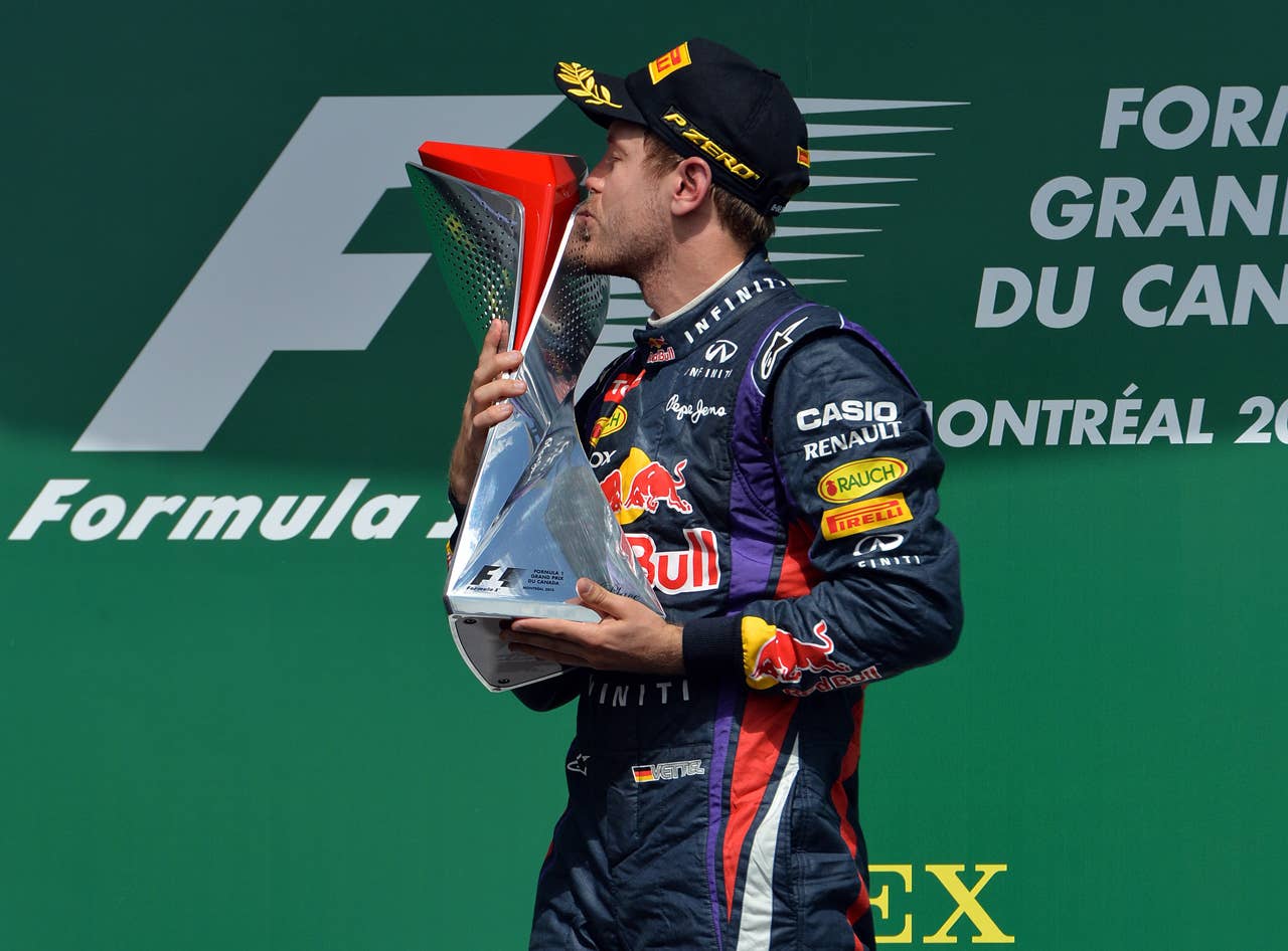 (CORRECTION-IPTC-BYLINE) Red Bull driver Sebastian Vettel of Germany kisses the trophy after winning the Canadian Formula One Grand Prix at the Circuit Gilles Villeneuve in Montreal on June 9, 2013.    AFP PHOTO/Stan HONDASTAN HONDA/AFP/Getty Images