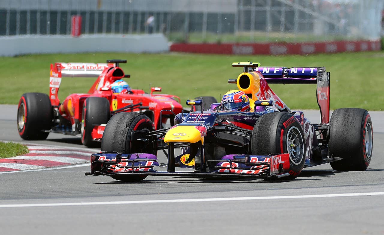 Red Bull driver Mark Webber of Australia powers his car ahead of Ferrari driver Felipe Massa of Brazil in the Canadian Formula One Grand Prix at the Circuit Gilles Villeneuve in Montreal on June 9, 2013. Webber placed fourth and Massa eighth.    AFP PHOTO/Emmanuel DunandEMMANUEL DUNAND/AFP/Getty Images