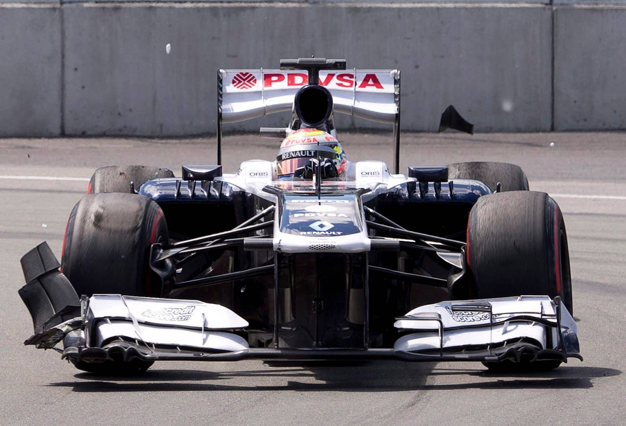 Williams driver Pastor Maldonado of Venezuela has pieces flying off his car and front wing after colliding with traffic in front of him at the beginning of the Canadian Grand Prix in Montreal, Sunday, June 9, 2013.  (AP Photo/The Canadian Press, Jacques Boissinot)
