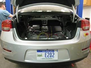 Replace the engine.  That was the first decision Regev and his chief engineer, Kevin Snyder, reached when beginning EcoCar2 at Wayne State. The LUK engine, which was the engine the team removed from the car, may be more advanced than the one they replaced it with. But the LE9 engine they opted for gave them a flex-fuel option that would allow them to run the car on E85, a fuel blend made primarily of corn-based ethanol.  Although they sacrificed some fuel efficiency with the choice, using E85 still helped the team achieve their goal of lowering use of traditional gasoline by approximately 85 percent and decreasing tailpipe emissions– two of the benchmarks in the competition.  Alternatives included using an engine that could run B20 diesel fuel and a hydrogen fuel cell that converted chemical energy from fuel into electricity. Most of the other EcoCar2 schools made the same ethanol choice. Four are using B20 diesel and one, Regev and Snyder heard through the grapevine, is attempting to build its own fuel cell.  "That would have been exotic," Regev said, smiling.  Given the time constraints, ethanol made the most sense.  Coupled with a hybrid system they'll soon install, the pair think they'll have the Malibu achieving 60 mpg by the time the competition ends next year.  The empty trunk space pictured to the left is where they're going to put the battery. It's lithium-ion hybrid from A123, and it weighs over 600 pounds.