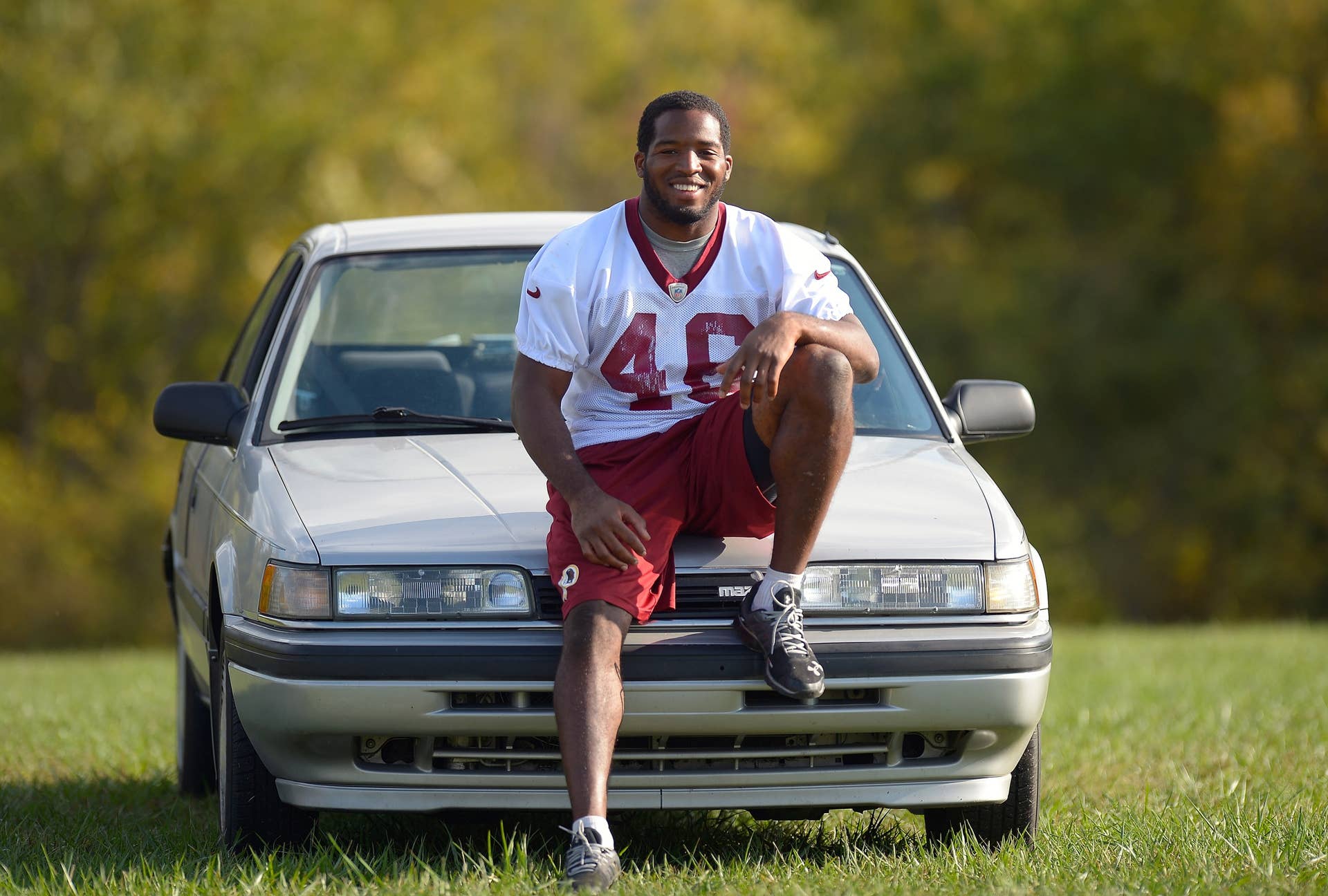 ASHBURN VA OCTOBER 4: Redskins' running back Alfred Morris poses with his 1991 Mazda 626 at Redskins Park in Ashburn VA , October 4, 2012 (Photo by John McDonnell/The Washington Post via Getty Images)