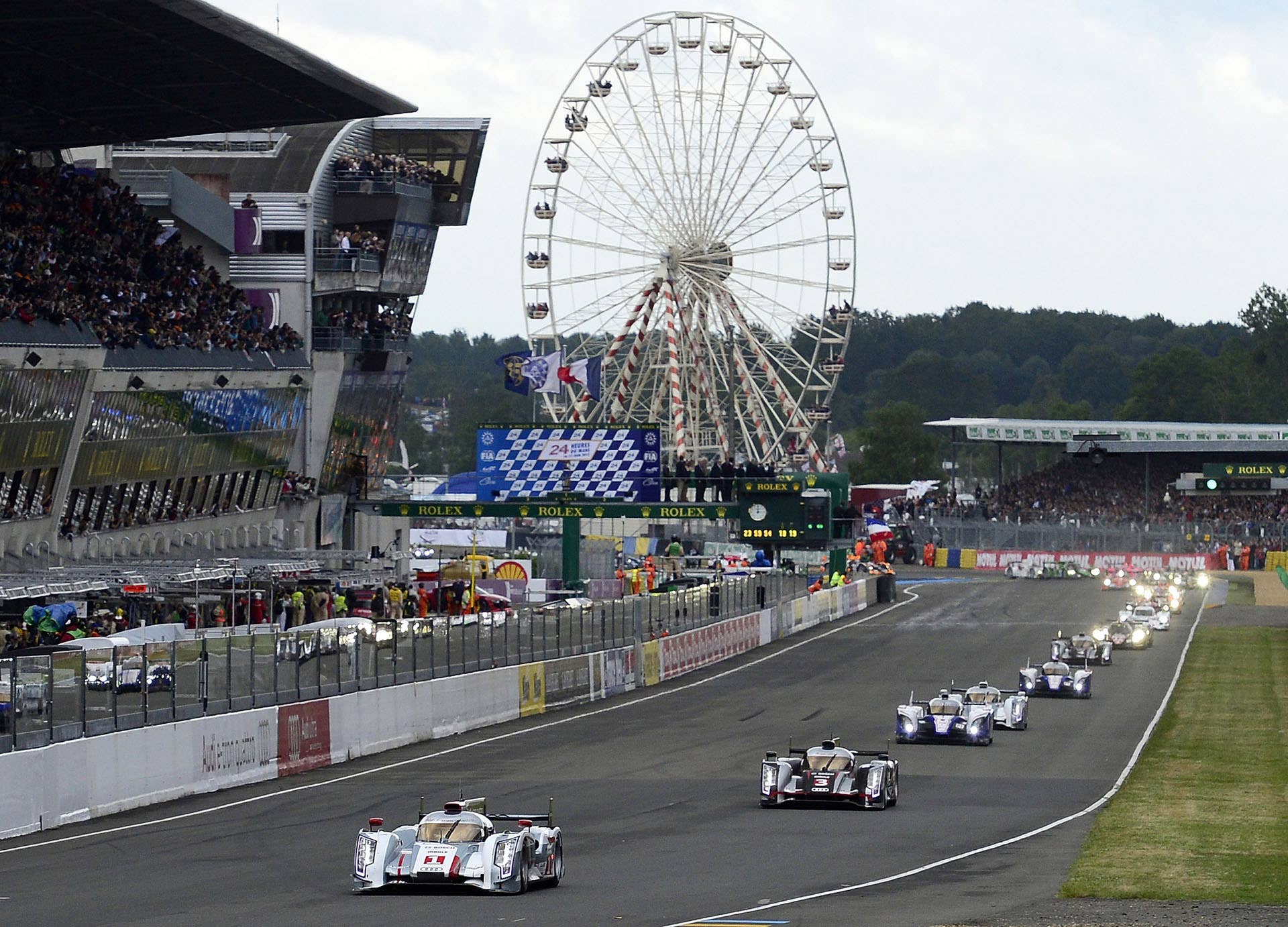 LE MANS, FRANCE - JUNE 16: Andre Lotterer of Germany and driver of the #1 Audi R18 e-tron quattro, takes the green flag and leads the field at the start of the 80th running of the Le Mans 24 Hour race at the Circuit des 24 Heures du Mans on June 16, 2012 in Le Mans, France (Photo by Rick Dole/Getty Images)