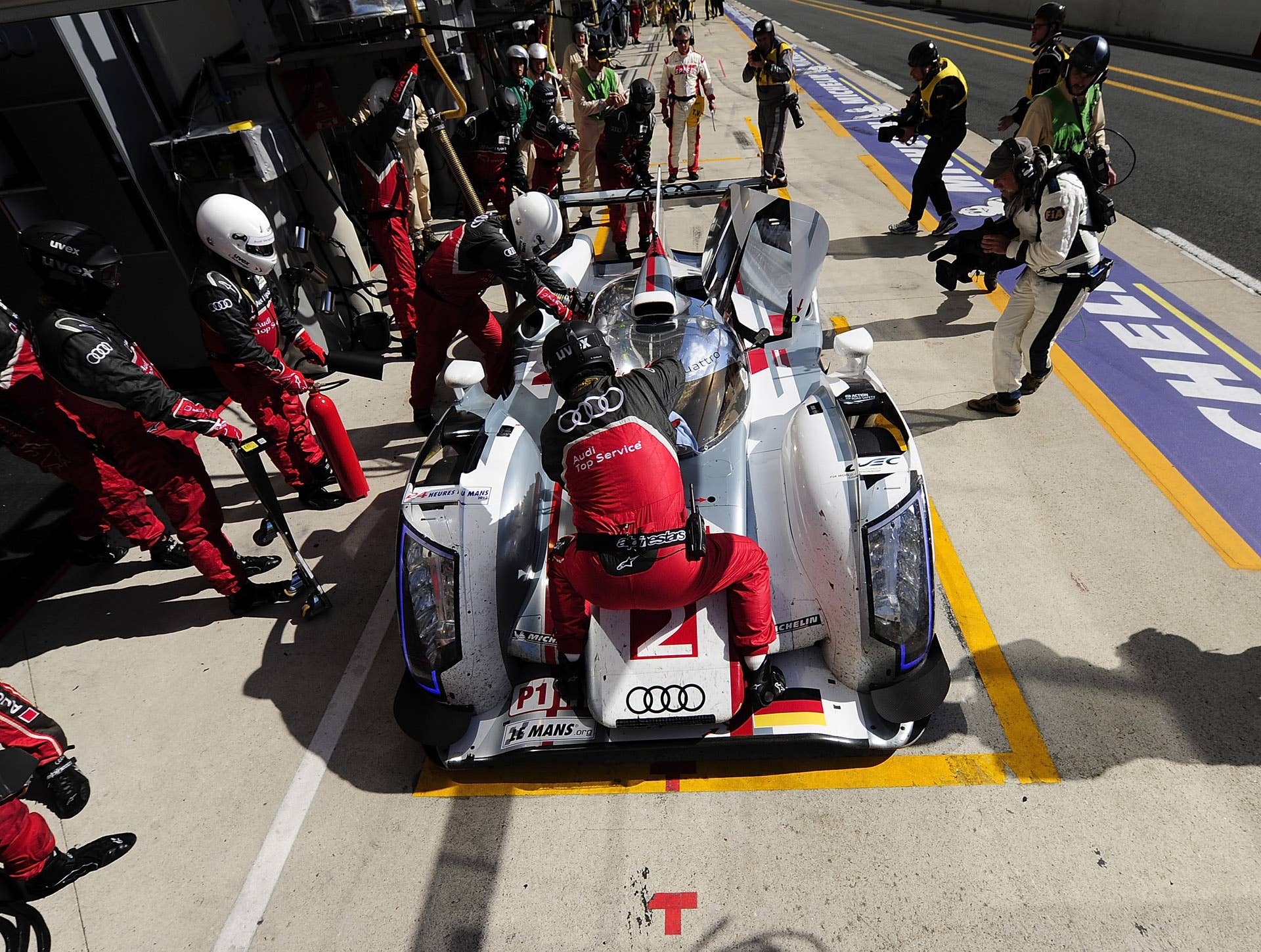 LE MANS, FRANCE - JUNE 16:  The # 2 Audi R18 e-tron quattro driven by Dindo Capello of Italy, Tom Kristensen of Denmark, and Allan McNish of Scotland, in for a pit stop during the 80th running of the Le Mans 24 Hour race at the Circuit des 24 Heures du Mans  on June 16, 2012 in Le Mans, France  (Photo by Rick Dole/Getty Images)