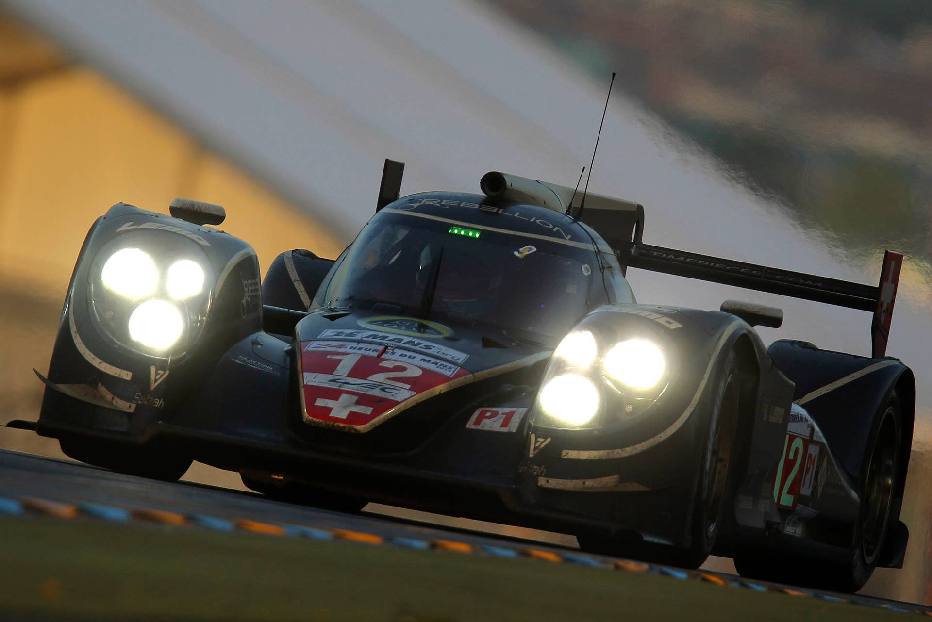 Nicolas Prost of France driving the Lola Rebellion No. 12 powers his car at daybreak during the 80th 24-hour Le Mans endurance race, in Le Mans, western France, Sunday, June 17, 2012. (AP Photo/David Vincent)