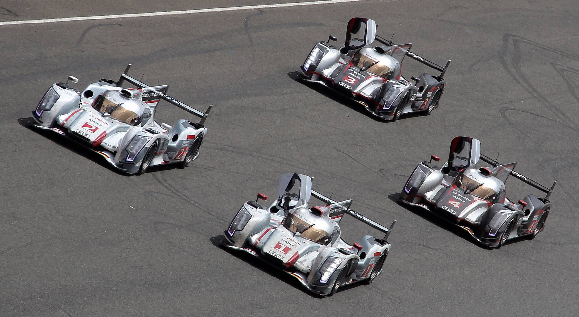 Audi R18 E-Tron Hybrid n1 driver Andre Lotterer of Germany jubilates as he crosses the finish line of the Le Mans 24-hour endurance race in Le Mans, western France, Sunday, June 17, 2012. It's the first time an hybrid car won Le Mans' endurance race. The 11th victory of Audi at Le Mans with the first three places of the race, with Audi n2 in second and Audi n4 in third. The Audi's n3 ended on the 5th place. (AP Photo/David Vincent)