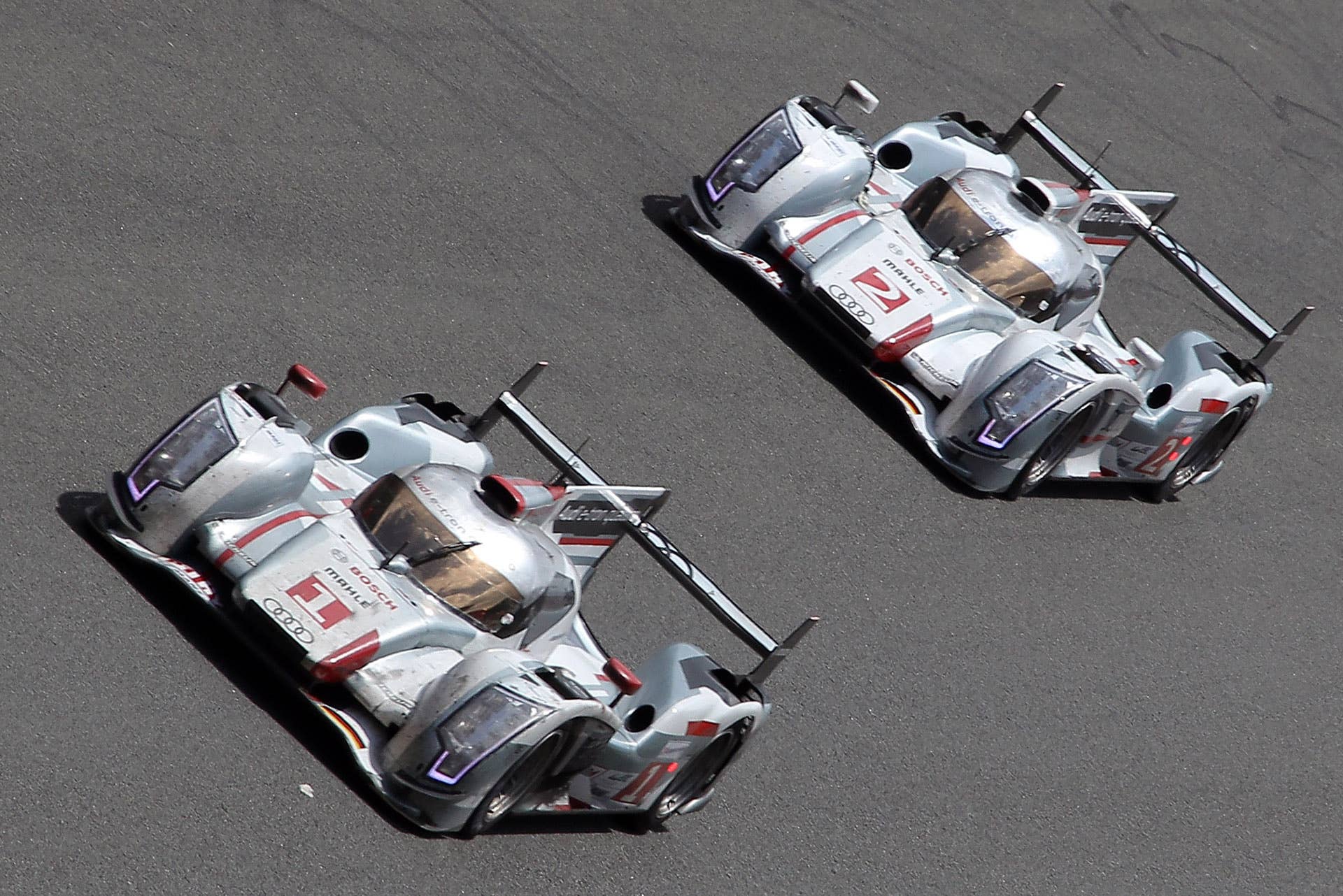 Audi R18 E-Tron Hybrid n1 driver Andre Lotterer of Germany is seen in action during the last lap ahead of Audi's n2 driver Tom Kristensen of Denmark to win the Le Mans 24-hour endurance race in Le Mans, western France, Sunday, June 17, 2012. It's the first time an hybrid car won Le Mans' endurance race. The 11th victory of Audi at Le Mans with the first three places of the race, with Audi n2 in second and Audi n4 in third. (AP Photo/David Vincent)