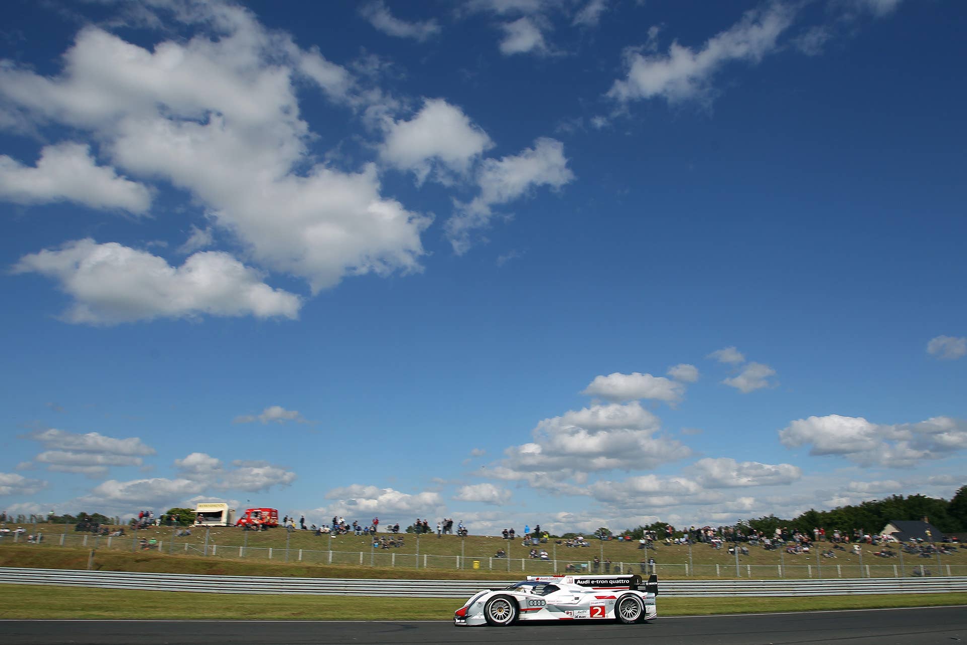 The Audi R18 E-Tron no 2 driven by Allan McNish of Scotland, Rinaldo Capello of Italy and Tom Kristensen of Denmark is seen in action during the 80th 24-hour Le Mans endurance race, in Le Mans, western France, Saturday, June 16, 2012. (AP Photo/David Vincent)