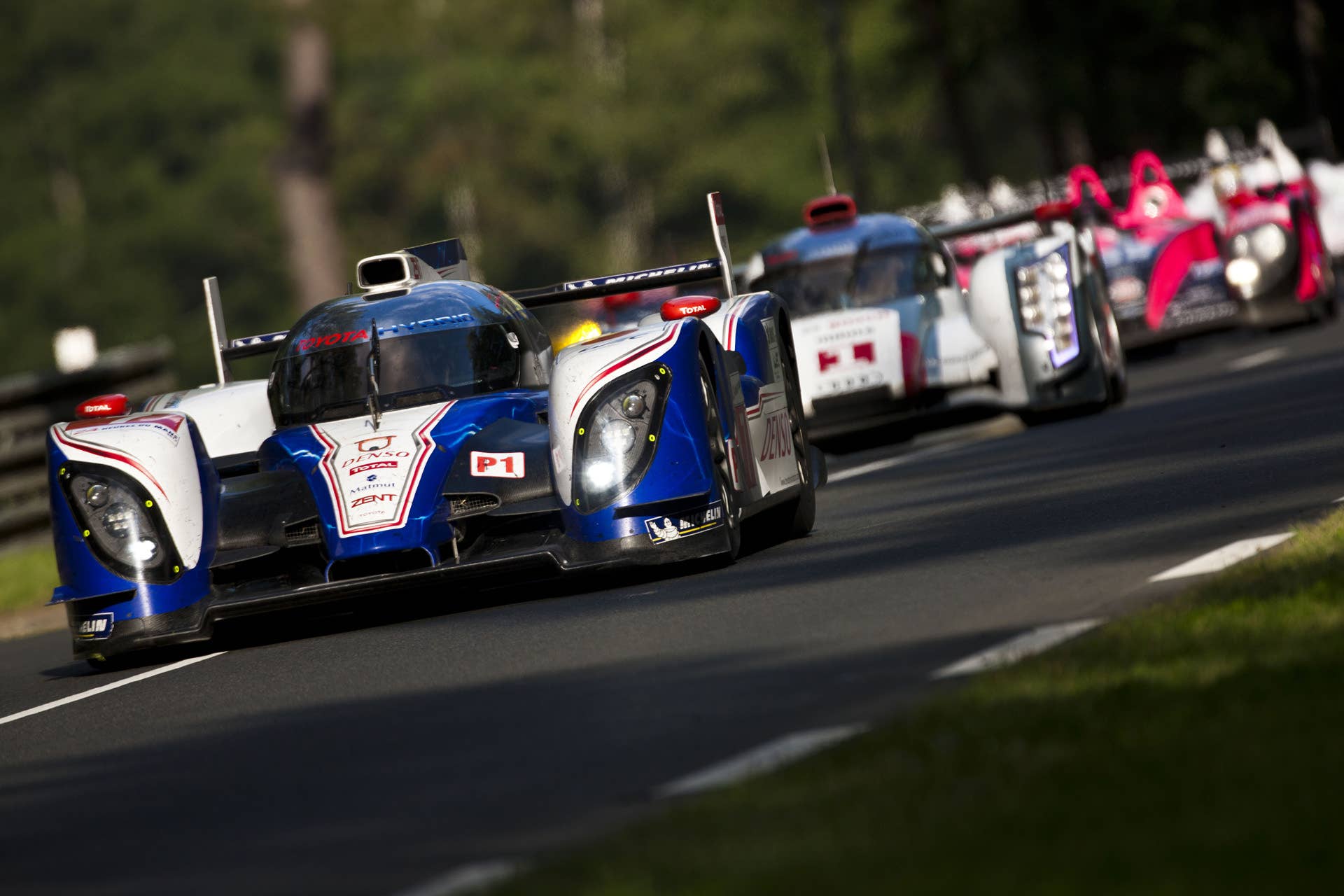 LE MANS, FRANCE - JUNE 16: The Toyota Racing Toyota TS 030 - Hybrid driven by Alexander Wurz of Austria, Nicolas Lapierre of France and Kazuki Nakajima of Japan leads The Audi Sport Team Joest Audi R18 e-tron quattro hybrid driven by Andre Lotterer of Germany, Benoit Treluyer of France and Marcel Fassler of Switzerland during the Le Mans 24 Hour race at the Circuit des 24 Heures du Mans on June 16, 2012 in Le Mans, France (Photo by Drew Gibson/Getty Images)