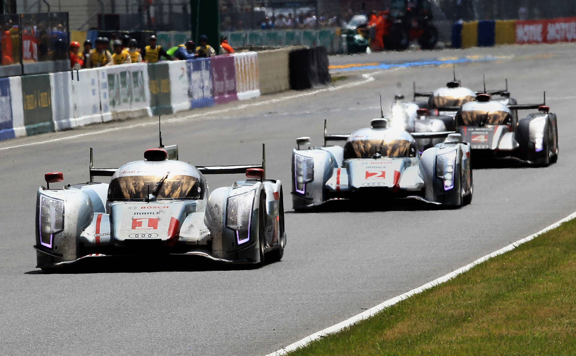 The four Audi R18 cars in action before win the 80th 24 hours Le Mans endurance race in Le Mans, western France, Sunday, June 17, 2012, with cars from left, No 1 driven by Andre Lotterrer of Germany and No.2 driven Tom Kristensen of Denmark, No4 driven by Mike Rickenfeller of Germany, No.3 driven by Loic Duval of France. Audi won the 24 Hours of Le Mans for the eleventh time on Sunday. (AP Photo/Bob Edme)