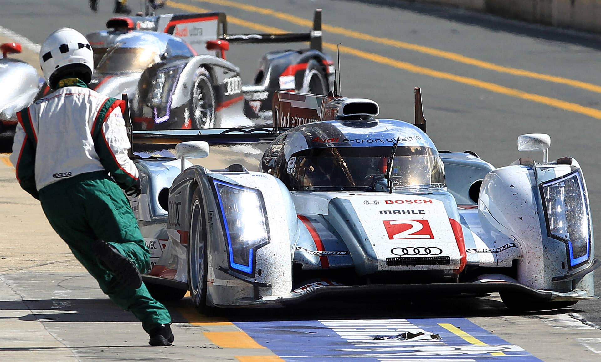 The Audi R18 TDI No driven by Allan Mac Nish of Scotland arrives at the pitlane during the 80th 24-hour Le Mans endurance race, in Le Mans, western France, Saturday, June 16, 2012. (AP Photo/Bob Edme)