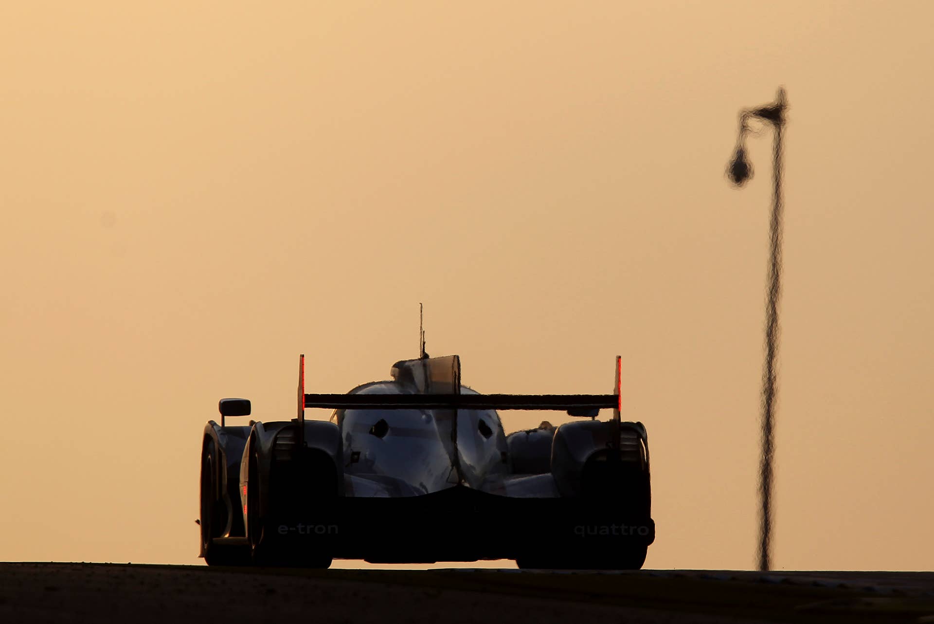 The Audi R18 e-tron No.1 driven by Andre Lotterer of Germany is seen in action at daybreak during the 80th 24-hour Le Mans endurance race, in Le Mans, western France, Sunday, June 17, 2012. (AP Photo/David Vincent)