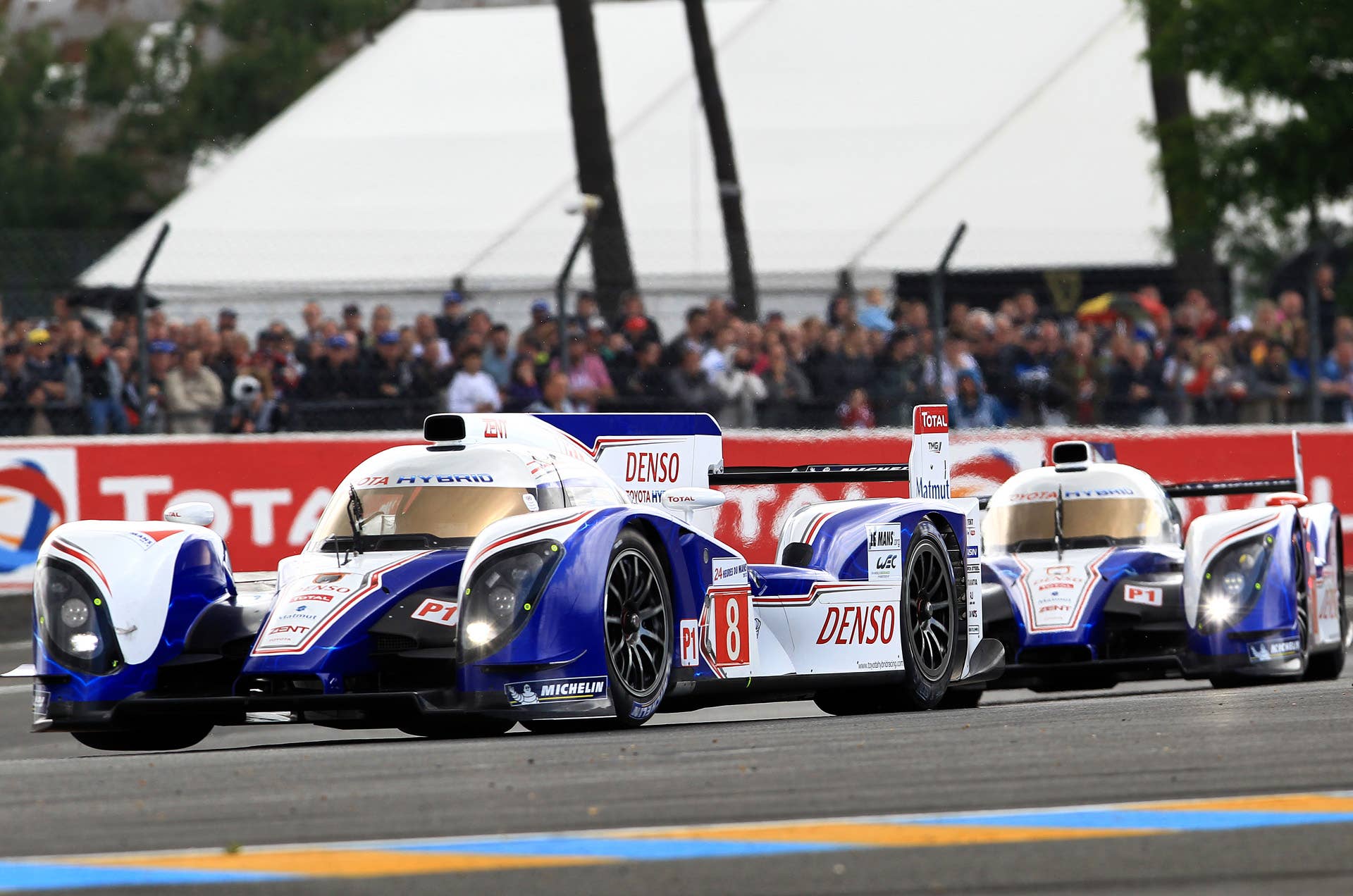 The both Toyota TS030 Hybrid No8 driven by Stephane Sarrazin of France, left, and No7 driven by Alexander Wurz of Germany, right, steer their car in a curve during the 80th 24-hour Le Mans endurance race, in Le Mans, western France, Saturday, June 16, 2012. (AP Photo/Bob Edme)