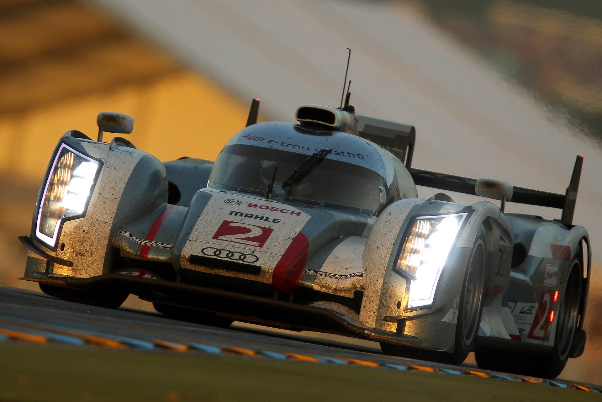 The Audi R18 e-tron No. 2 driven by Tom Kristensen of Denmark is seen in action at daybreak during the 80th 24-hour Le Mans endurance race, in Le Mans, western France, Sunday, June 17, 2012. (AP Photo/David Vincent)