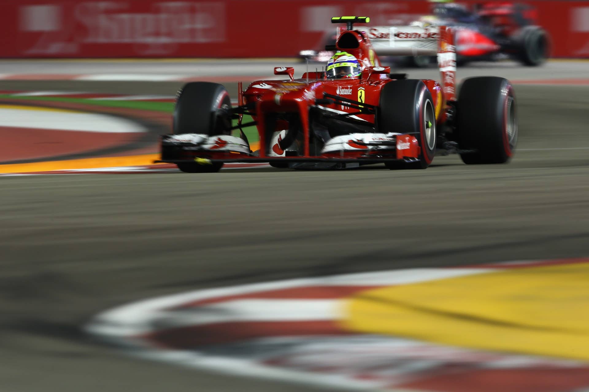 SINGAPORE - SEPTEMBER 22:  Felipe Massa of Brazil and Ferrari drives during the Singapore Formula One Grand Prix at Marina Bay Street Circuit on September 22, 2013 in Singapore, Singapore.  (Photo by Paul Gilham/Getty Images)