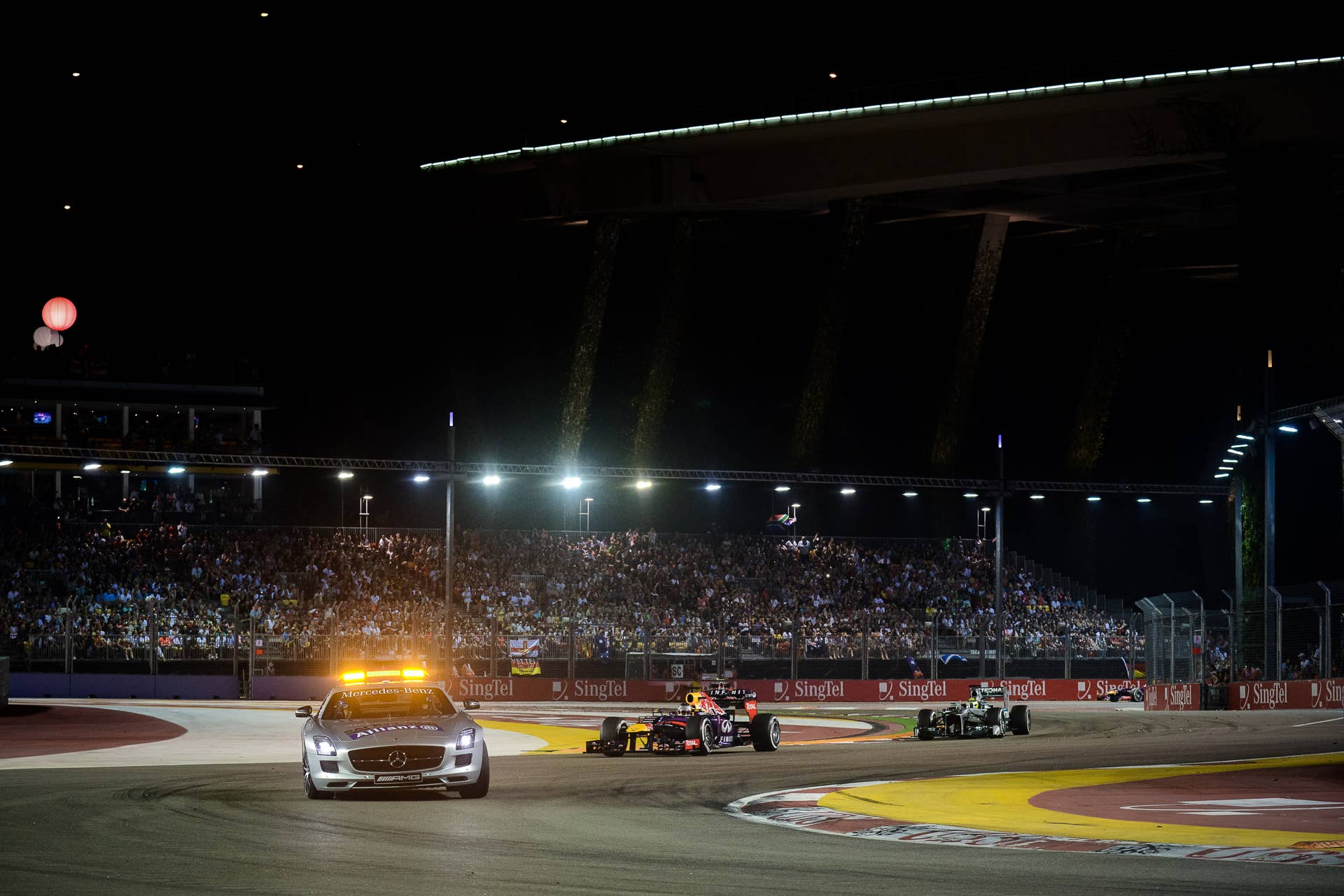 Red Bull driver Sebastian Vettel of Germany drives behind the safety car during the Formula One Singapore Grand Prix on September 22, 2013.   AFP PHOTO / Philippe Lopez        (Photo credit should read PHILIPPE LOPEZ/AFP/Getty Images)