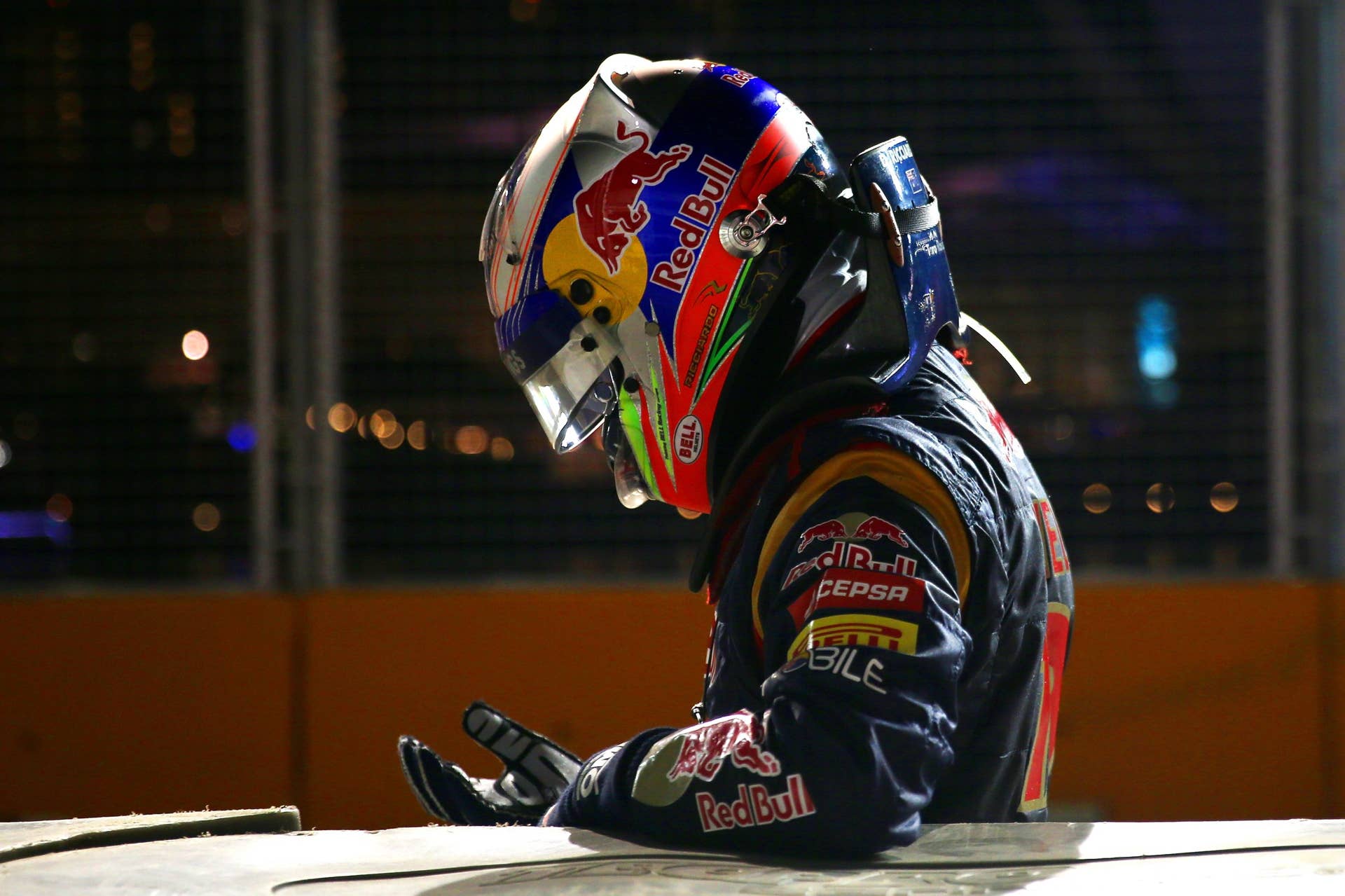 SINGAPORE - SEPTEMBER 22:  A dejected Daniel Ricciardo of Australia and Scuderia Toro Rosso reacts after crashing into a barrier during the Singapore Formula One Grand Prix at Marina Bay Street Circuit on September 22, 2013 in Singapore, Singapore.  (Photo by Mark Thompson/Getty Images)