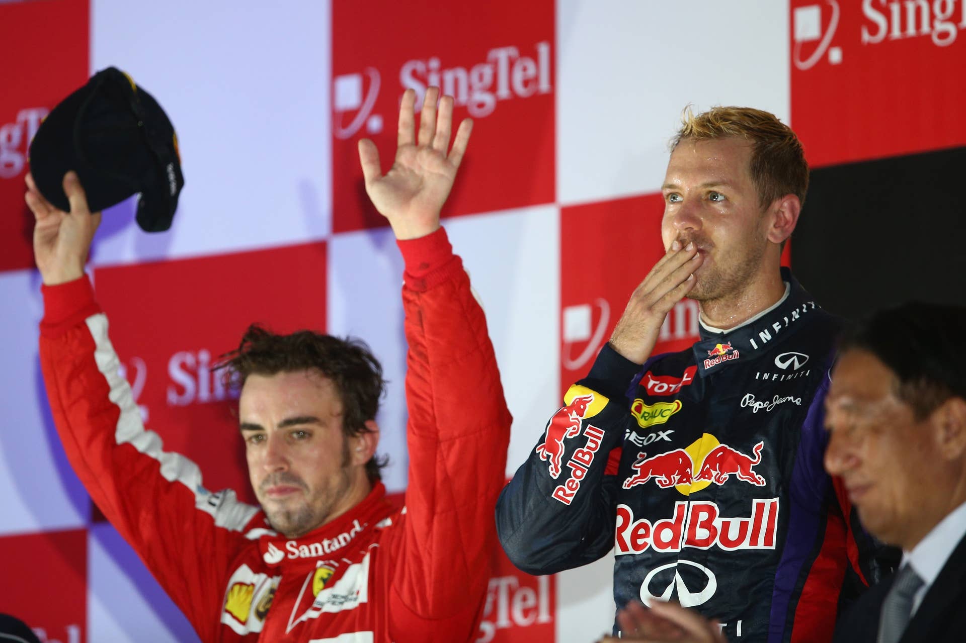 SINGAPORE - SEPTEMBER 22:  Sebastian Vettel of Germany and Infiniti Red Bull racing celebrates following his victory during the Singapore Formula One Grand Prix at Marina Bay Street Circuit on September 22, 2013 in Singapore, Singapore.  (Photo by Paul Gilham/Getty Images)