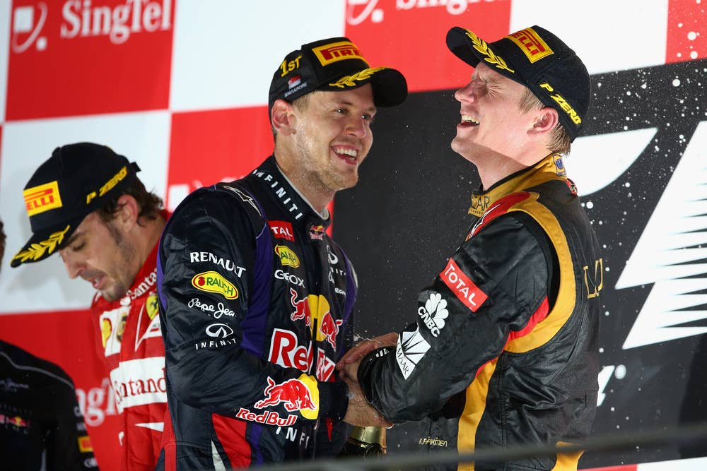 SINGAPORE - SEPTEMBER 22:  (L-R) Fernando Alonso (2nd place) of Spain and Ferrari, Sebastian Vettel (1st place) of Germany and Red Bull Racing and Kimi Raikkonen (3rd place) of Finland and Lotus celebrate on the podium following the Singapore Formula One Grand Prix at Marina Bay Street Circuit on September 22, 2013 in Singapore, Singapore.  (Photo by Paul Gilham/Getty Images)
