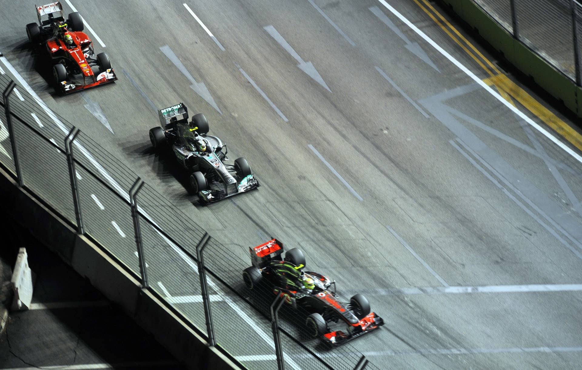 McLaren-Mercedes driver Sergio Perez of Mexico (bottom R), Mercedes driver Lewis Hamilton of Britain (C) and Ferrari driver Felipe Massa of Brazil (top L) race during the Formula One Singapore Grand Prix on September 22, 2013.   AFP PHOTO / MOHD FYROL        (Photo credit should read MOHD FYROL/AFP/Getty Images)
