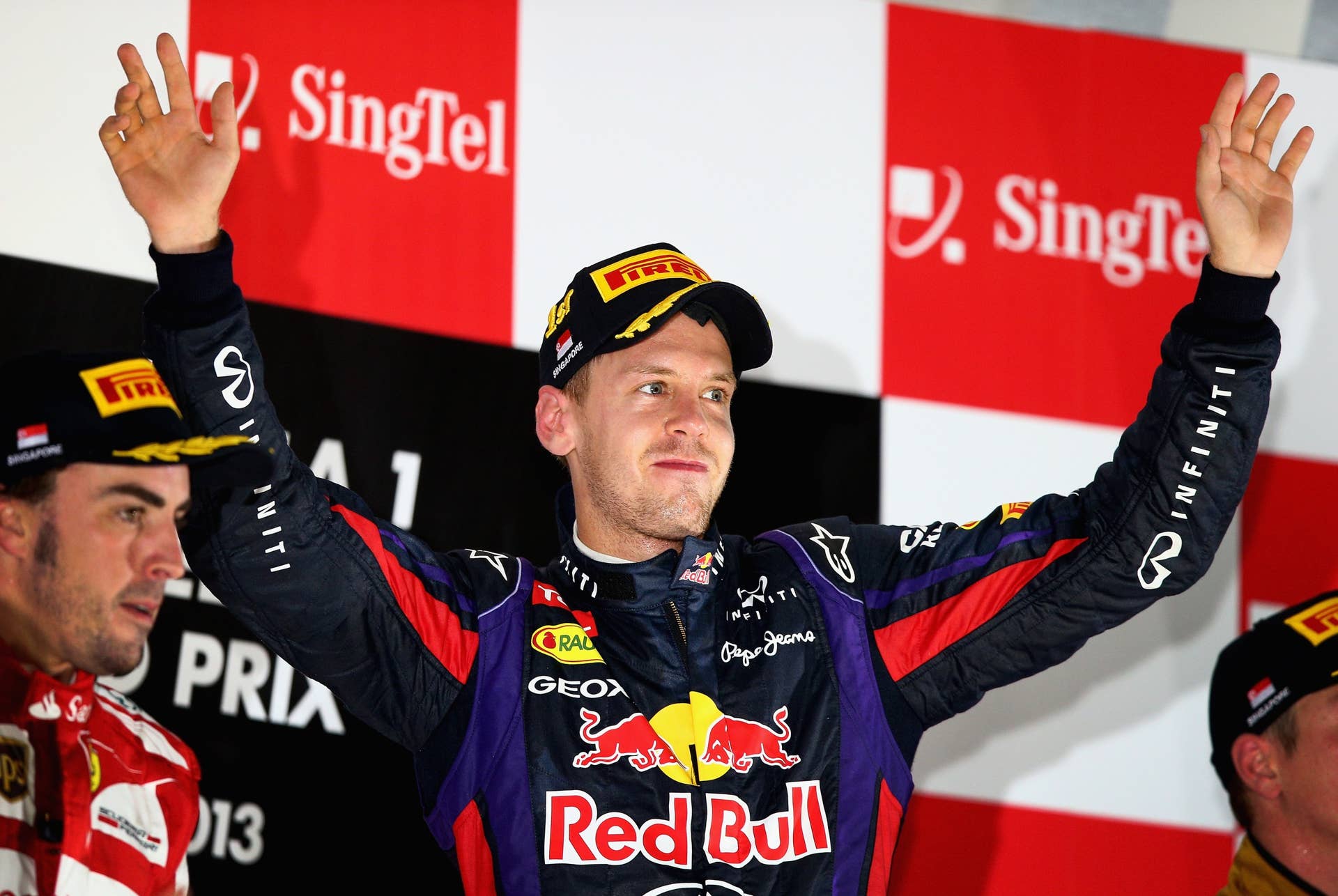 SINGAPORE - SEPTEMBER 22:  Sebastian Vettel of Germany and Infiniti Red Bull racing celebrates following his victory during the Singapore Formula One Grand Prix at Marina Bay Street Circuit on September 22, 2013 in Singapore, Singapore.  (Photo by Clive Mason/Getty Images)
