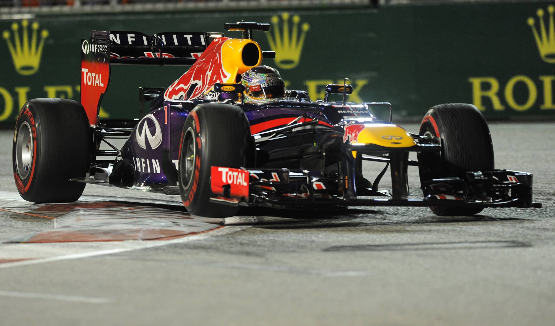 Red Bull driver Sebastian Vettel of Germany drives during the Formula One Singapore Grand Prix on September 22, 2013.    AFP PHOTO / ROSLAN RAHMAN        (Photo credit should read ROSLAN RAHMAN/AFP/Getty Images)