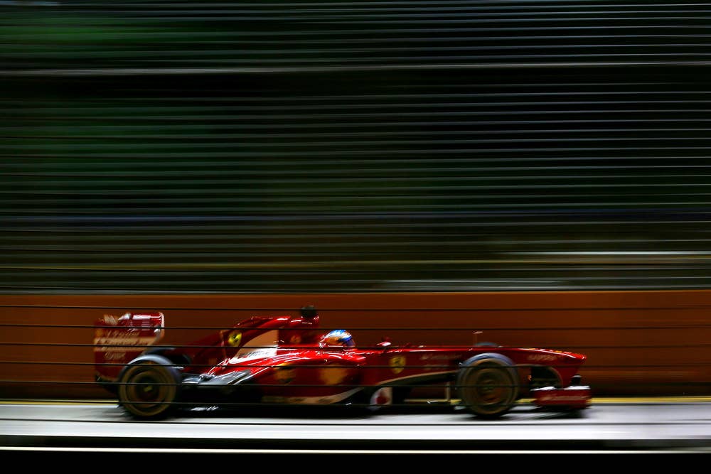 SINGAPORE - SEPTEMBER 22: Fernando Alonso of Spain and Ferrari drives during the Singapore Formula One Grand Prix at Marina Bay Street Circuit on September 22, 2013 in Singapore, Singapore.