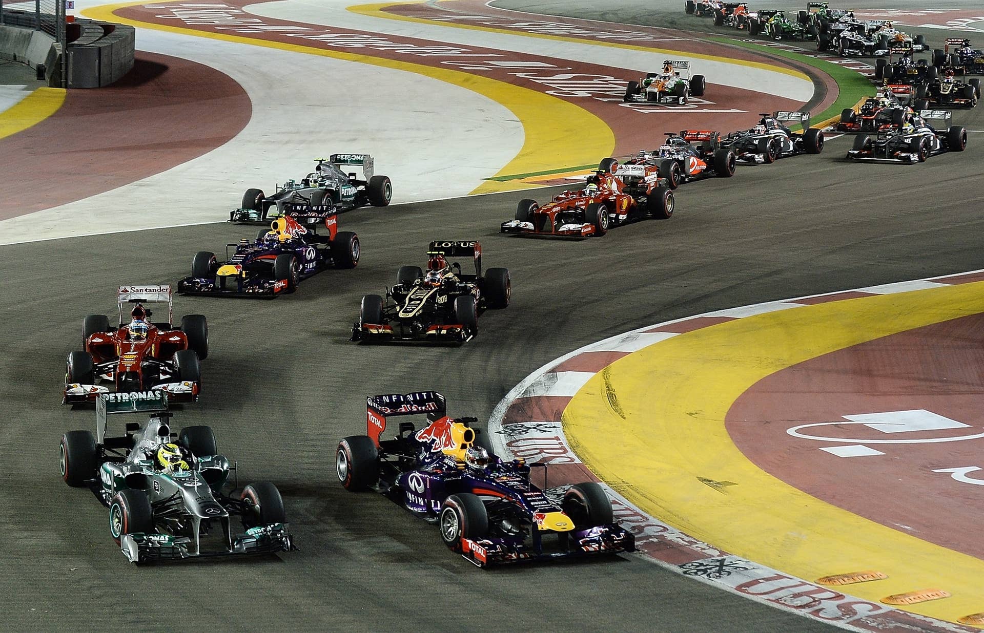 Red Bull-Renault driver Sebastian Vettel of Germany (bottom R) leads the pack at the start of the Formula One Singapore Grand Prix on September 22, 2013.   AFP PHOTO / MANAN VATSYAYANA        (Photo credit should read MANAN VATSYAYANA/AFP/Getty Images)