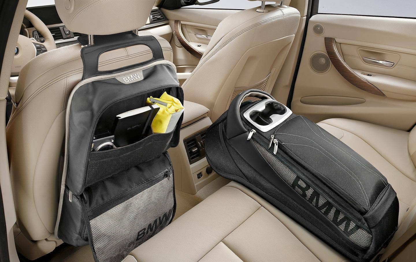 Backrest Bag, Modern/Basic  This multi-pocketed companion easily attaches to the rear of the drivers or front passengers seat. Made from hard-wearing, easy-to-clean material. / Rear Storage Bag, Modern/Basic  A combination of exceptional design and intelligent functionality. Attaches to the back seat with the center seat belt. Provides useful additional storage and includes two exterior cupholders. Made from hard-wearing material.