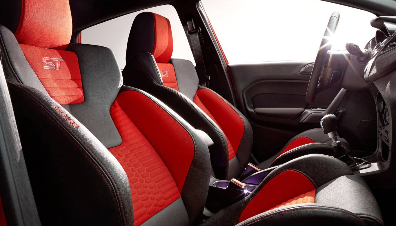 Interior space up front is quite good. Head, shoulder and elbow room are better than you might think, given the car's overall size. The rear seats are a little cramped, which is to be expected in a subcompact, especially if the front seats are pushed back. Adults probably won't be too thrilled to ride back there.  The trunk itself isn't huge, but the rear bench easily splits 60/40, giving the Fiesta ST a lot of cargo room. This, coupled with its hatch, gives the car loads of versatility.  Research the Ford Fiesta ST Ford Fiesta ST Overview Ford Fiesta ST Photos & Video Ford Fiesta ST Local Dealer Price Quote