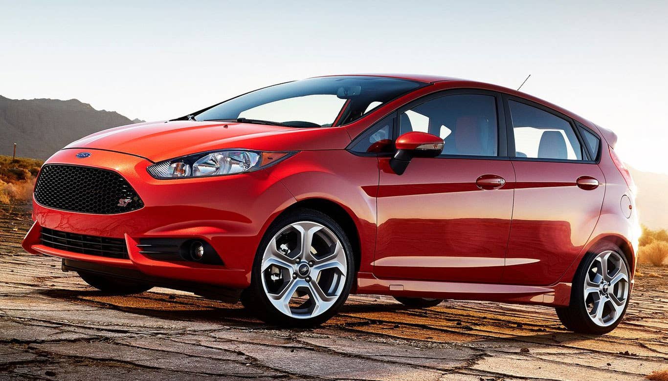 Little car, big fun.  That's probably the best way to describe the Ford Fiesta ST, a new car for the 2014 model year. Sure, it may look like your garden variety commuter vehicle, better suited for trips to Trader Joe's than the track, but believe me when I say this hatch is hot.  Some maniacal genius at Ford looked at the dainty Fiesta and decided to do something bold and seemingly nonsensical, outfitting it with a much more potent engine, lowering the ride height and tightening up the handling. This turned the Fiesta ST into a true, bonafide sports car, capable of delighting everyone from experienced drivers to novices that simply want to spice up their travel time.  I recently got to spend an entire week behind the wheel of the Fiesta ST. From now on, whenever I'm having a bad day, I'm simply going to think of that week and the fact that this car actually exists, in turn reminding myself that someone, somewhere is getting to experience it.  Research the Ford Fiesta ST Ford Fiesta ST Overview Ford Fiesta ST Photos & Video Ford Fiesta ST Local Dealer Price Quote