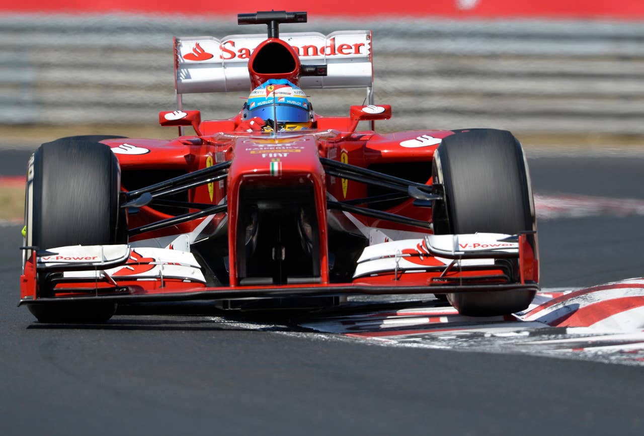 Ferrari driver Fernando Alonso of Spain sterrs his race car during the Formula One Hungarian Grand Prix at the Hungaroring racetrack, near Budapest, Hungary, Sunday, July 28, 2013. (AP Photo/Bela Szandelszky)