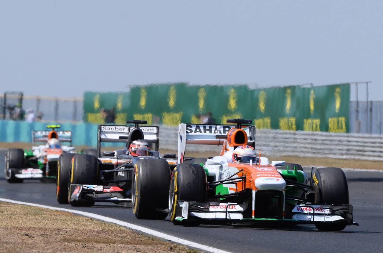 (L to R) Force India's German driver Adrian Sutil, Sauber's German driver Nico Hulkenberg and Force India's Scottish driver Paul di Resta drive at the Hungaroring circuit in Budapest on July 28, 2013 during the Hungarian Formula One Grand Prix.    AFP PHOTO / ATTILA KISBENEDEKATTILA KISBENEDEK/AFP/Getty Images