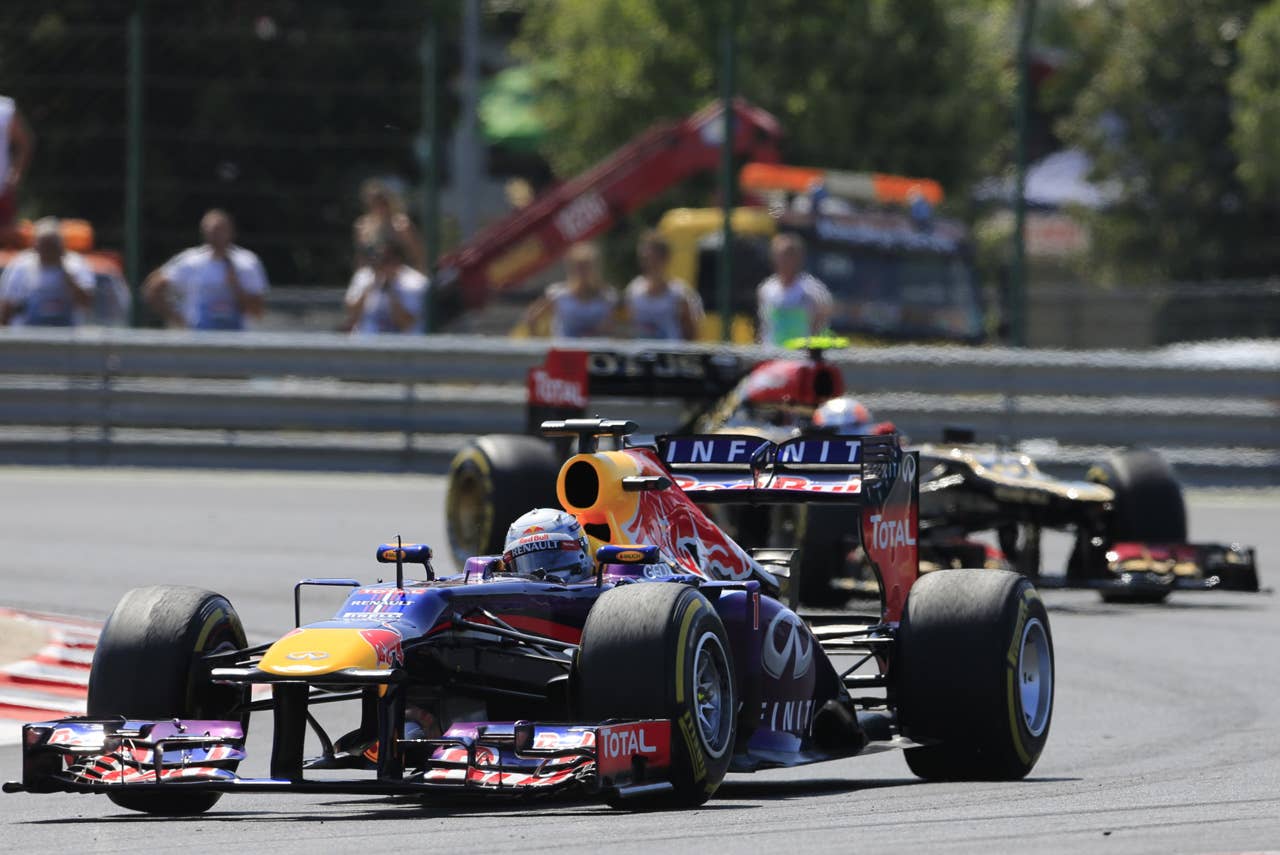 Red Bull Racing's German driver Sebastian Vettel and Lotus F1 Team's French driver Romain Grosjean   drive at the Hungaroring circuit in Budapest on July 28, 2013 during the Hungarian Formula One Grand Prix. AFP PHOTO / ALEXANDER KLEINALEXANDER KLEIN/AFP/Getty Images