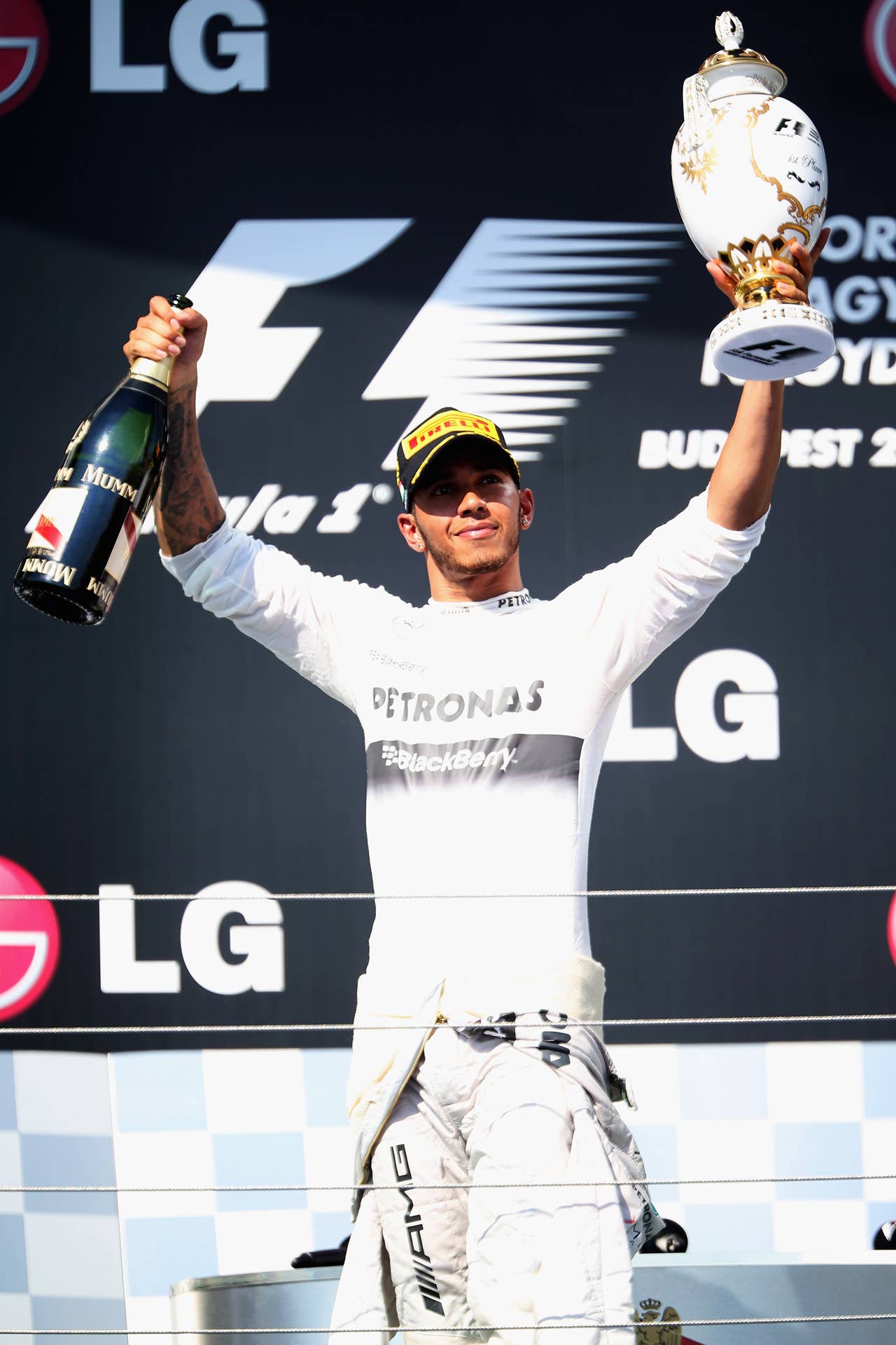 BUDAPEST, HUNGARY - JULY 28:  Lewis Hamilton of Great Britain and Mercedes GP celebrates on the podium after winning the Hungarian Formula One Grand Prix at Hungaroring on July 28, 2013 in Budapest, Hungary.  (Photo by Mark Thompson/Getty Images)