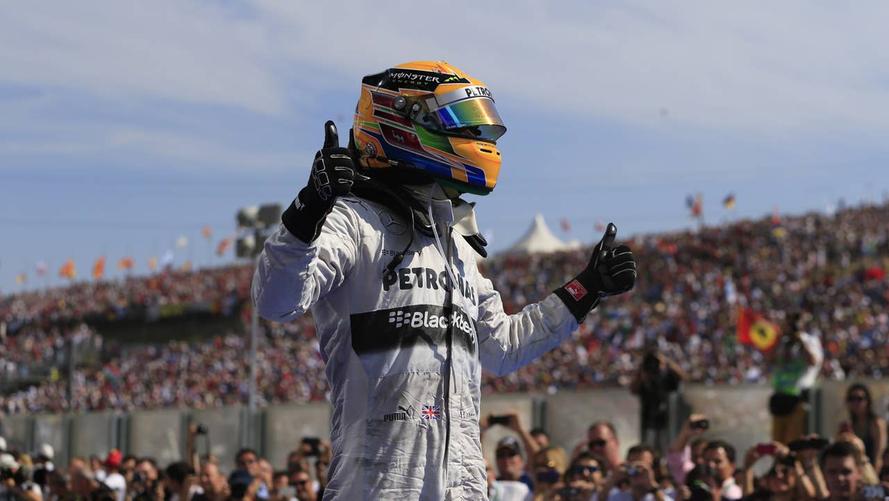 TOPSHOTS Mercedes'  British driver Lewis Hamilton celebrates in the parc ferme at the Hungaroring circuit in Budapest on July 28, 2013 during the Hungarian Formula One Grand Prix. AFP PHOTO / ALEXANDER KLEINALEXANDER KLEIN/AFP/Getty Images