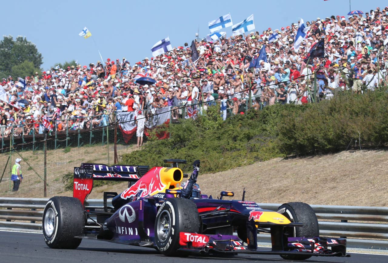TOPSHOTS Red Bull Racing's German driver Sebastian Vettel waves after finishing third at the Hungaroring circuit in Budapest on July 28, 2013 during the Hungarian Formula One Grand Prix.     AFP PHOTO / FERENC ISZAFERENC ISZA/AFP/Getty Images
