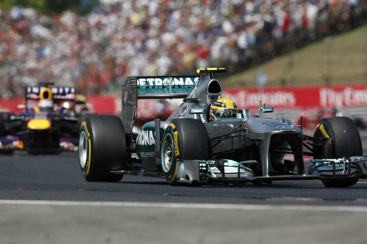 Red Bull Racing's German driver Sebastian Vettel and Mercedes'  British driver Lewis Hamilton drives  at the Hungaroring circuit in Budapest on July 28, 2013 during the Hungarian Formula One Grand Prix.     AFP PHOTO / FERENC ISZABors Isza Ferenc/AFP/Getty Images