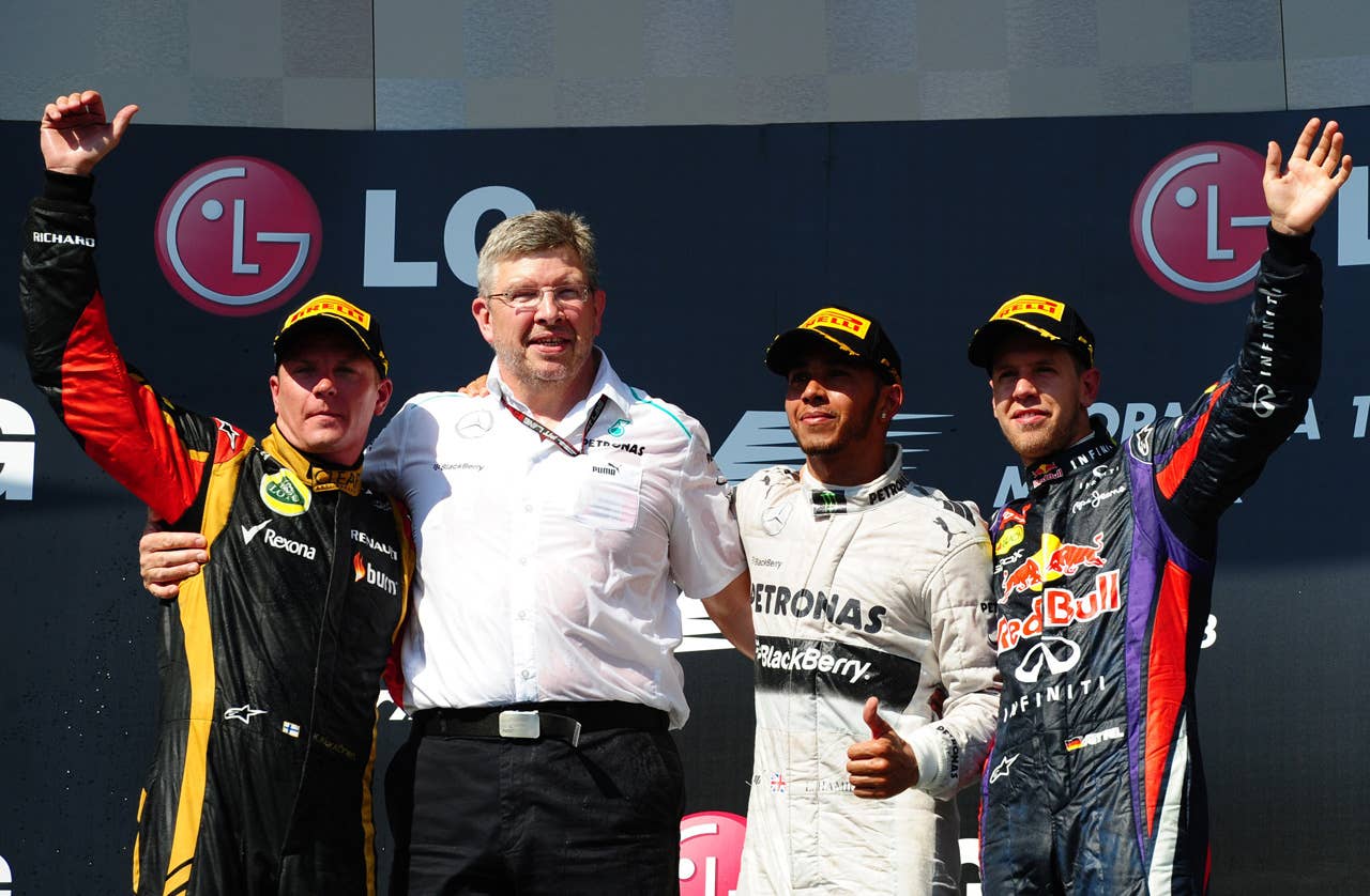(L to R) Lotus F1 Team's Finnish driver Kimi Raikkonen Mercedes Team Principal Ross Brawn Mercedes'  British driver Lewis Hamilton and Red Bull Racing's German driver Sebastian Vettel celebrate on the podium at the Hungaroring circuit in Budapest on July 28, 2013 after the Hungarian Formula One Grand Prix.   AFP PHOTO / TOM GANDOLFINITom Gandolfini/AFP/Getty Images