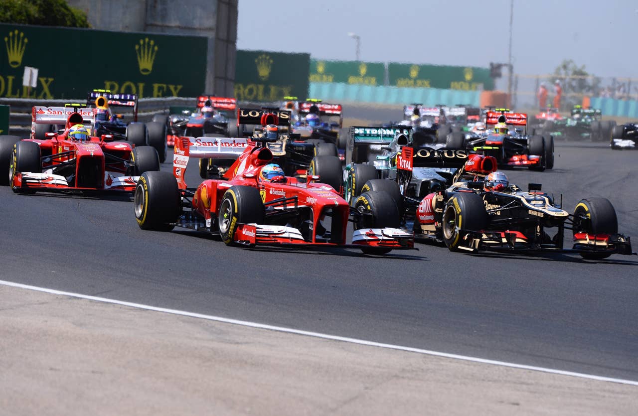 Drivers race after the start at the Hungaroring circuit in Budapest on July 28, 2013 during the Hungarian Formula One Grand Prix.    AFP PHOTO / ATTILA KISBENEDEKATTILA KISBENEDEK/AFP/Getty Images