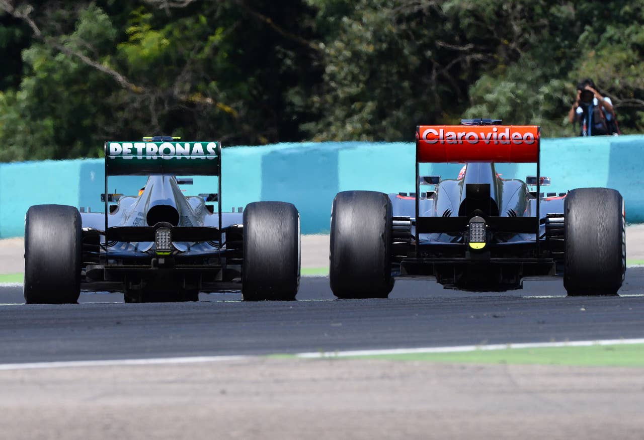 McLaren Mercedes' British driver Jenson Button (R) and Mercedes'  British driver Lewis Hamilton   drive at the Hungaroring circuit in Budapest on July 28, 2013 during the Hungarian Formula One Grand Prix.    AFP PHOTO / ATTILA KISBENEDEKATTILA KISBENEDEK/AFP/Getty Images