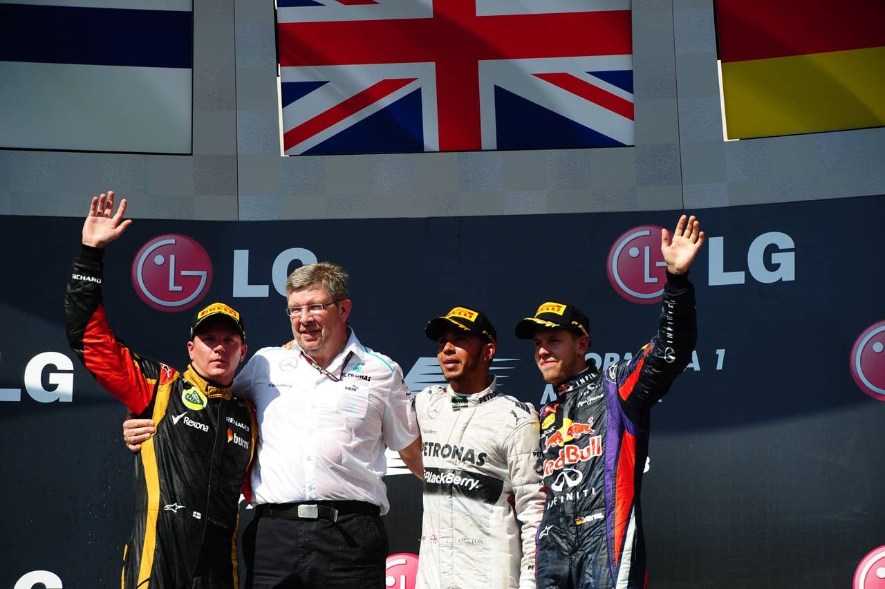(L to R) Lotus F1 Team's Finnish driver Kimi Raikkonen, Mercedes Team Principal Ross Brawn Mercedes' British driver Lewis Hamilton and Red Bull Racing's German driver Sebastian Vettel celebrate on the podium at the Hungaroring circuit in Budapest on July 28, 2013 after the Hungarian Formula One Grand Prix.   AFP PHOTO / TOM GANDOLFINITom Gandolfini/AFP/Getty Images