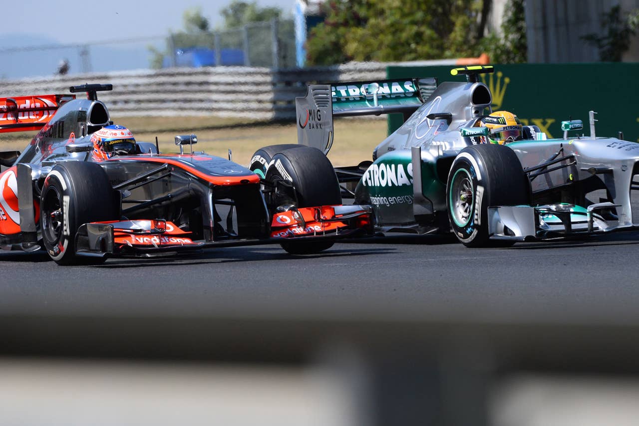 (L to R) McLaren Mercedes' British driver Jenson Button and Mercedes'  British driver Lewis Hamilton race at the Hungaroring circuit in Budapest on July 28, 2013 during the Hungarian Formula One Grand Prix.    AFP PHOTO / ATTILA KISBENEDEKATTILA KISBENEDEK/AFP/Getty Images