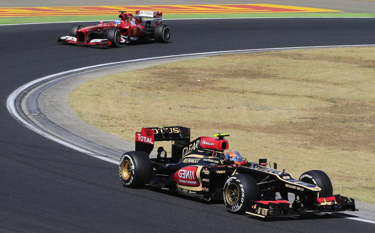 Ferrari's Spanish driver Fernando Alonso  and Lotus F1 Team's French driver Romain Grosjean drive at the Hungaroring circuit in Budapest on July 28, 2013 during the Hungarian Formula One Grand Prix. AFP PHOTO / ALEXANDER KLEINALEXANDER KLEIN/AFP/Getty Images
