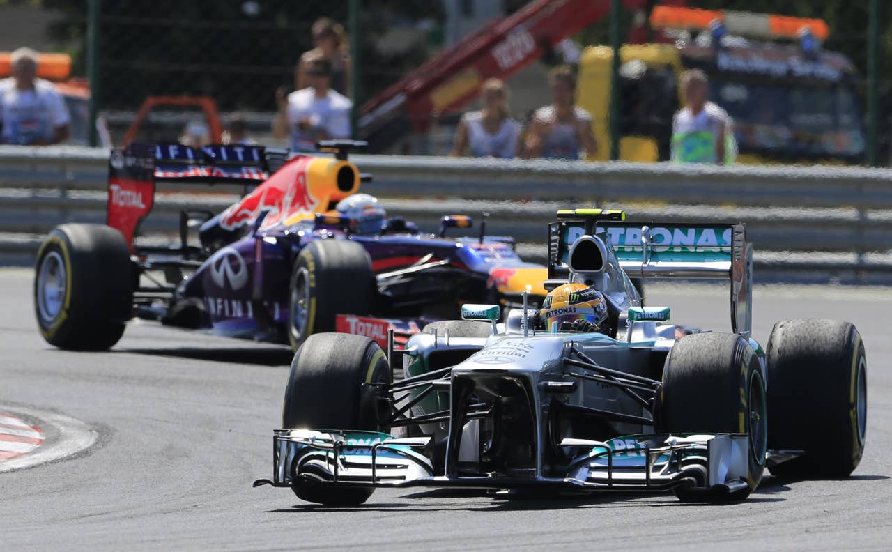 Red Bull Racing's German driver Sebastian Vettel and Mercedes'  British driver Lewis Hamilton  drive at the Hungaroring circuit in Budapest on July 28, 2013 during the Hungarian Formula One Grand Prix. AFP PHOTO / ALEXANDER KLEINALEXANDER KLEIN/AFP/Getty Images