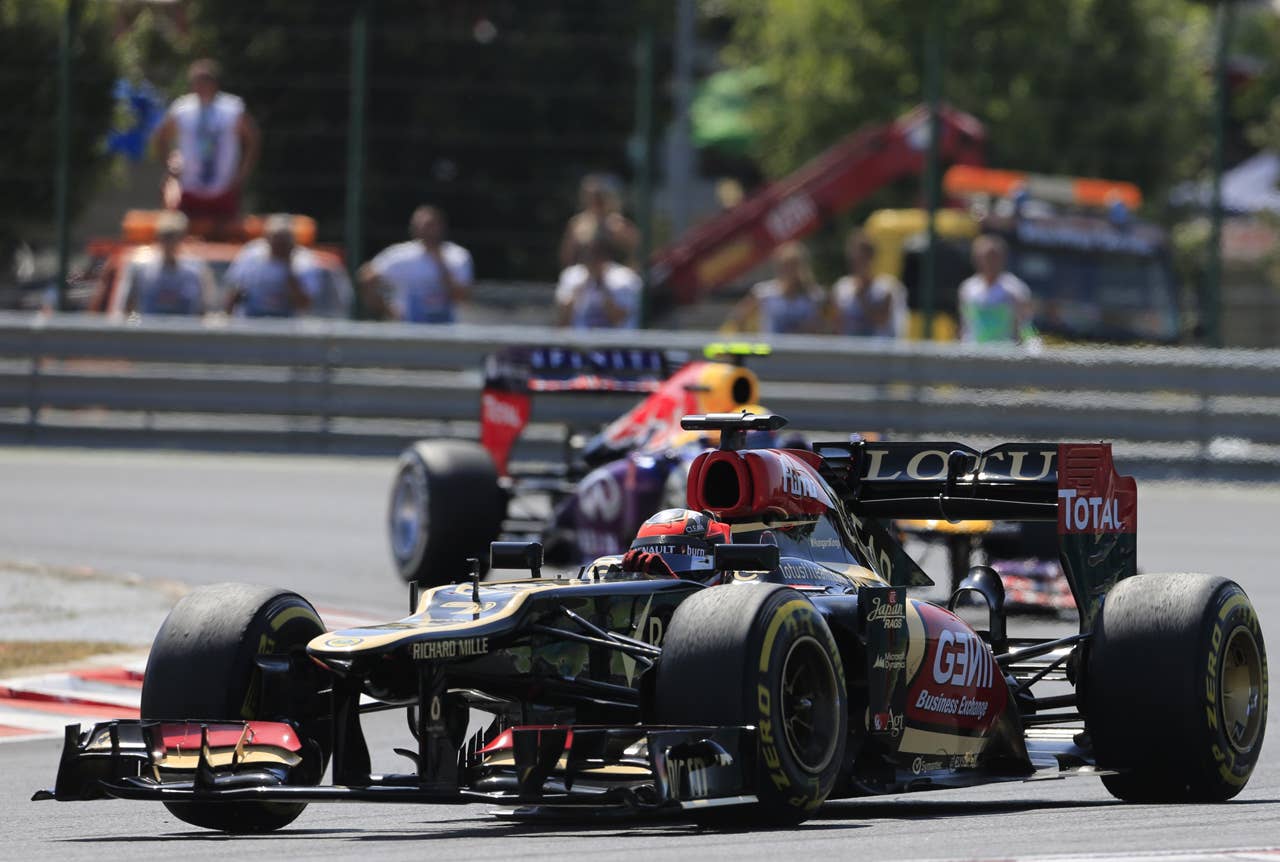 Lotus F1 Team's Finnish driver Kimi Raikkonen and Red Bull Racing's Australian driver Mark Webber drive at the Hungaroring circuit in Budapest on July 28, 2013 during the Hungarian Formula One Grand Prix. AFP PHOTO / ALEXANDER KLEINALEXANDER KLEIN/AFP/Getty Images