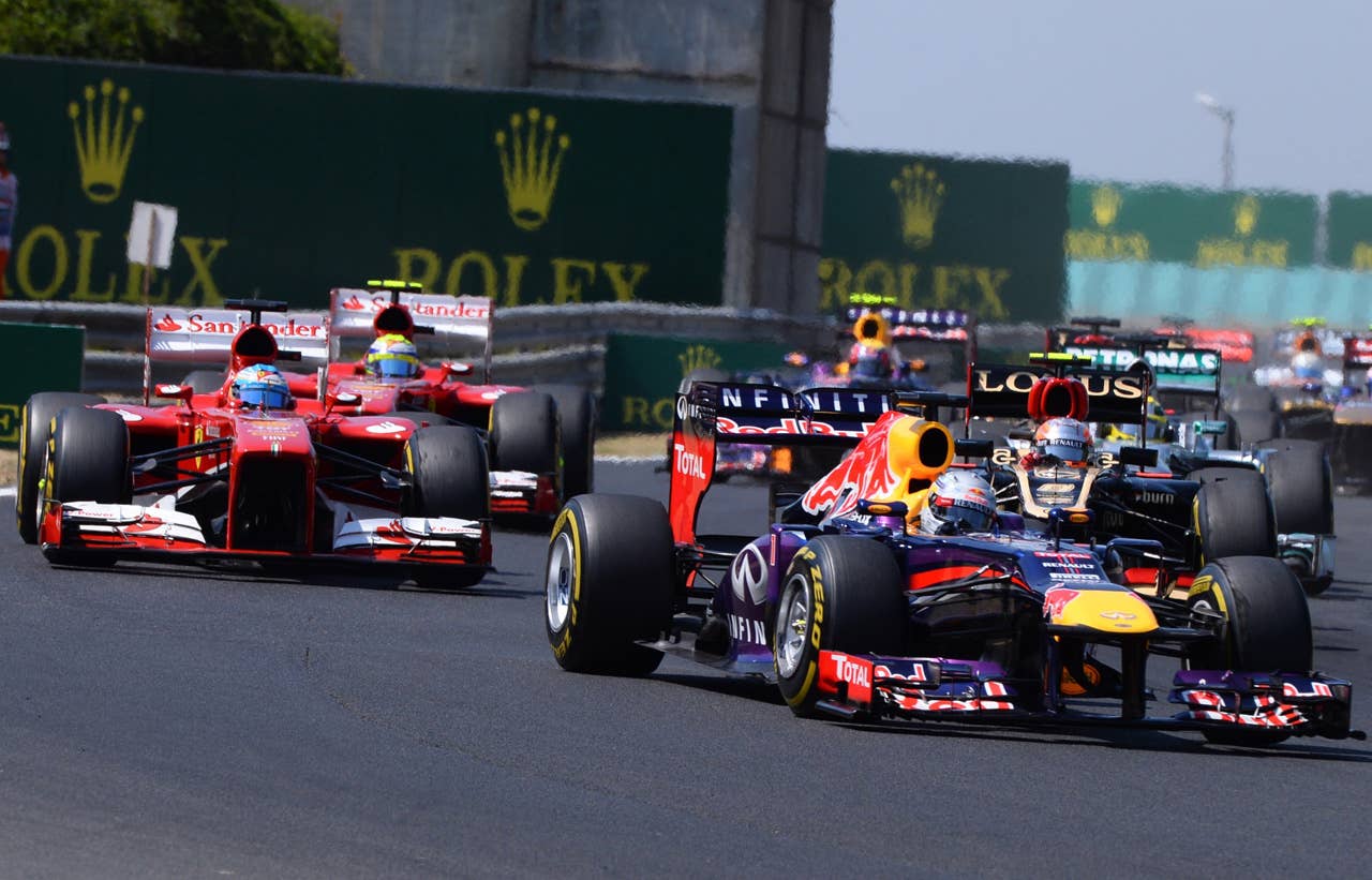 Drivers race at the Hungaroring circuit in Budapest on July 28, 2013 during the Hungarian Formula One Grand Prix.    AFP PHOTO / ATTILA KISBENEDEKATTILA KISBENEDEK/AFP/Getty Images